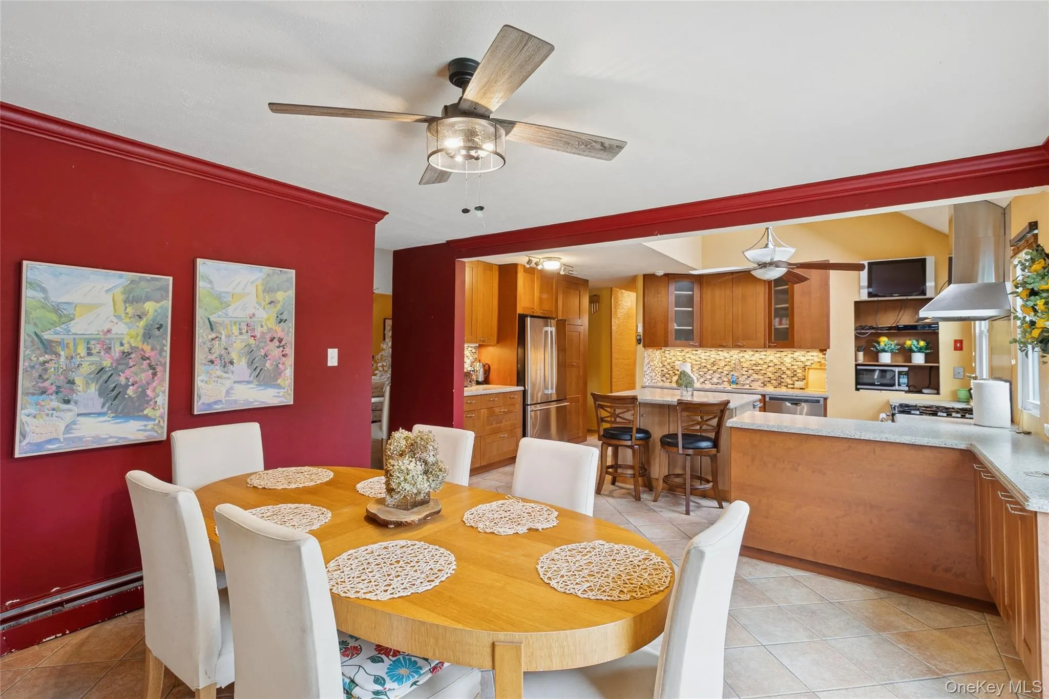 Dining room with light tile patterned flooring, a ceiling fan, and crown molding Dining room with light tile patterned flooring, a ceiling fan, and crown molding