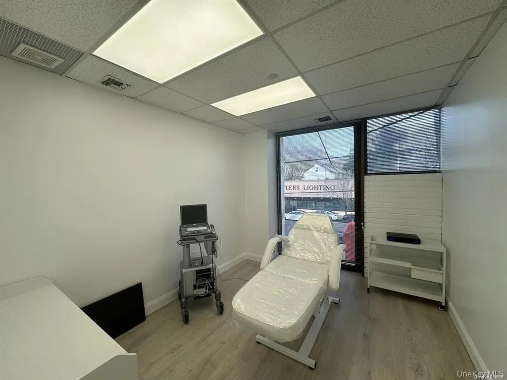 Bedroom with light wood finished floors and a drop ceiling Bedroom with light wood finished floors and a drop ceiling