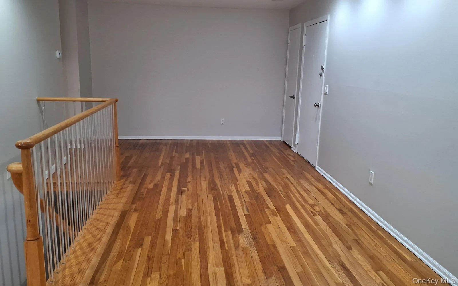 Spare room with light wood-style floors and baseboards Spare room with light wood-style floors and baseboards