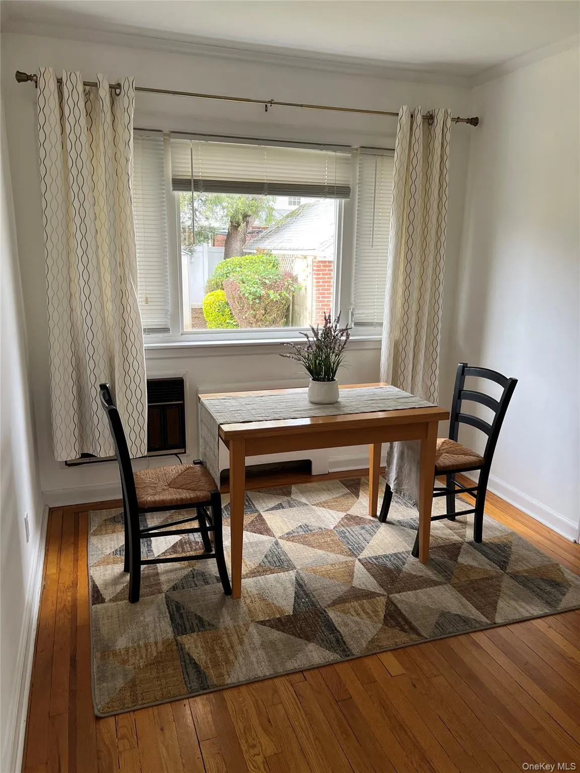 Sitting room featuring light wood finished floors and ornamental molding Sitting room featuring light wood finished floors and ornamental molding