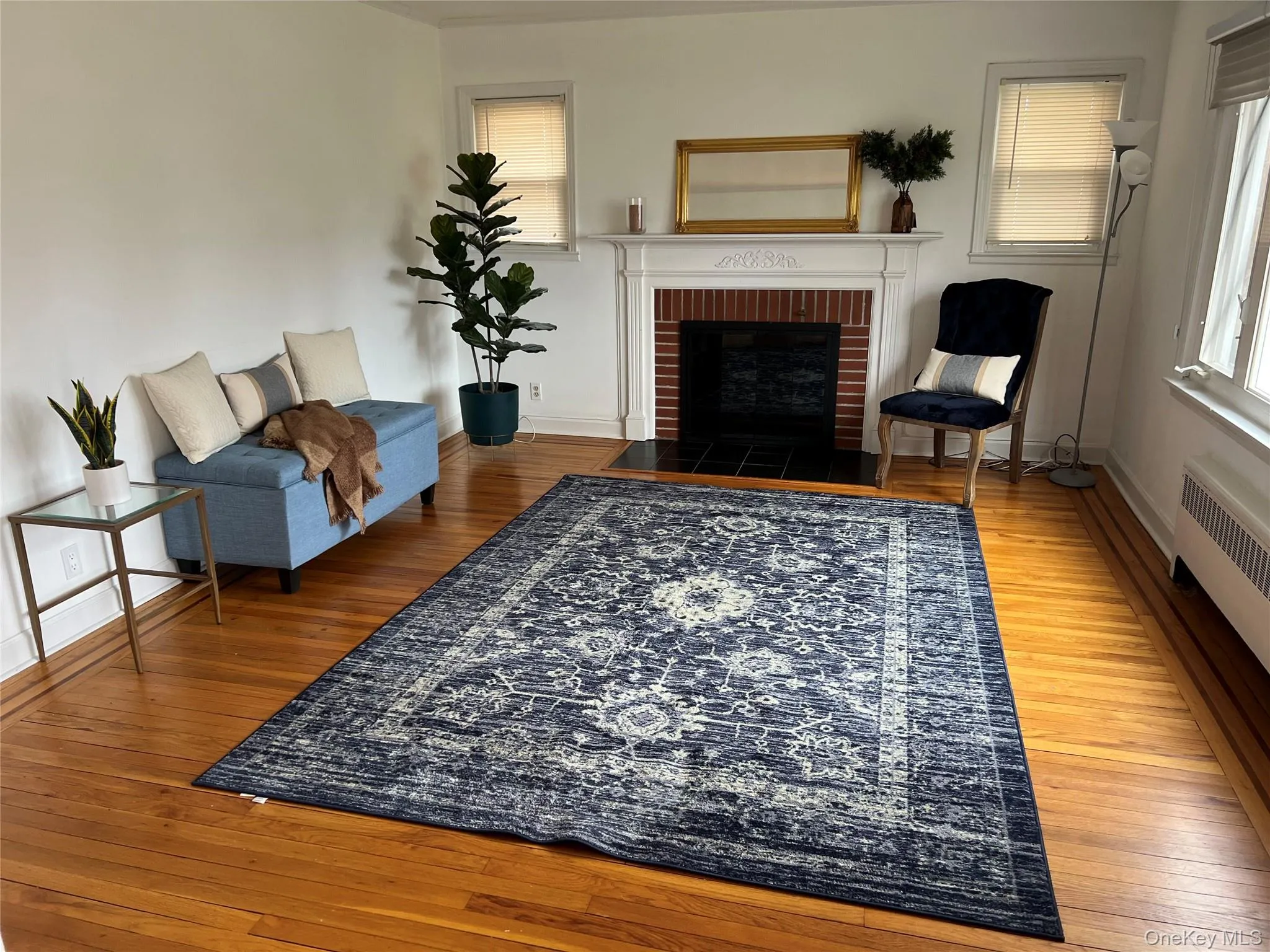 Living area featuring light wood finished floors, a fireplace, and healthy amount of natural light Living area featuring light wood finished floors, a fireplace, and healthy amount of natural light