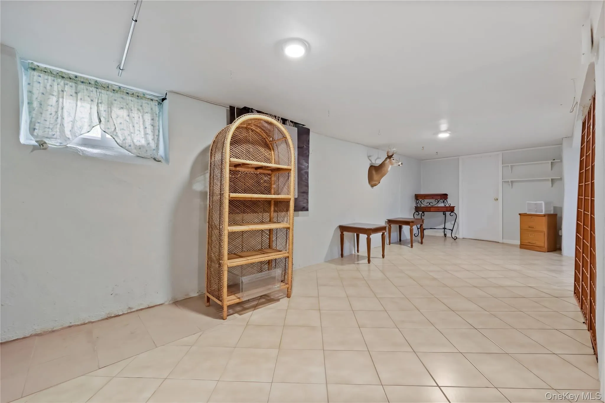 Below grade area with light tile patterned flooring Below grade area with light tile patterned flooring