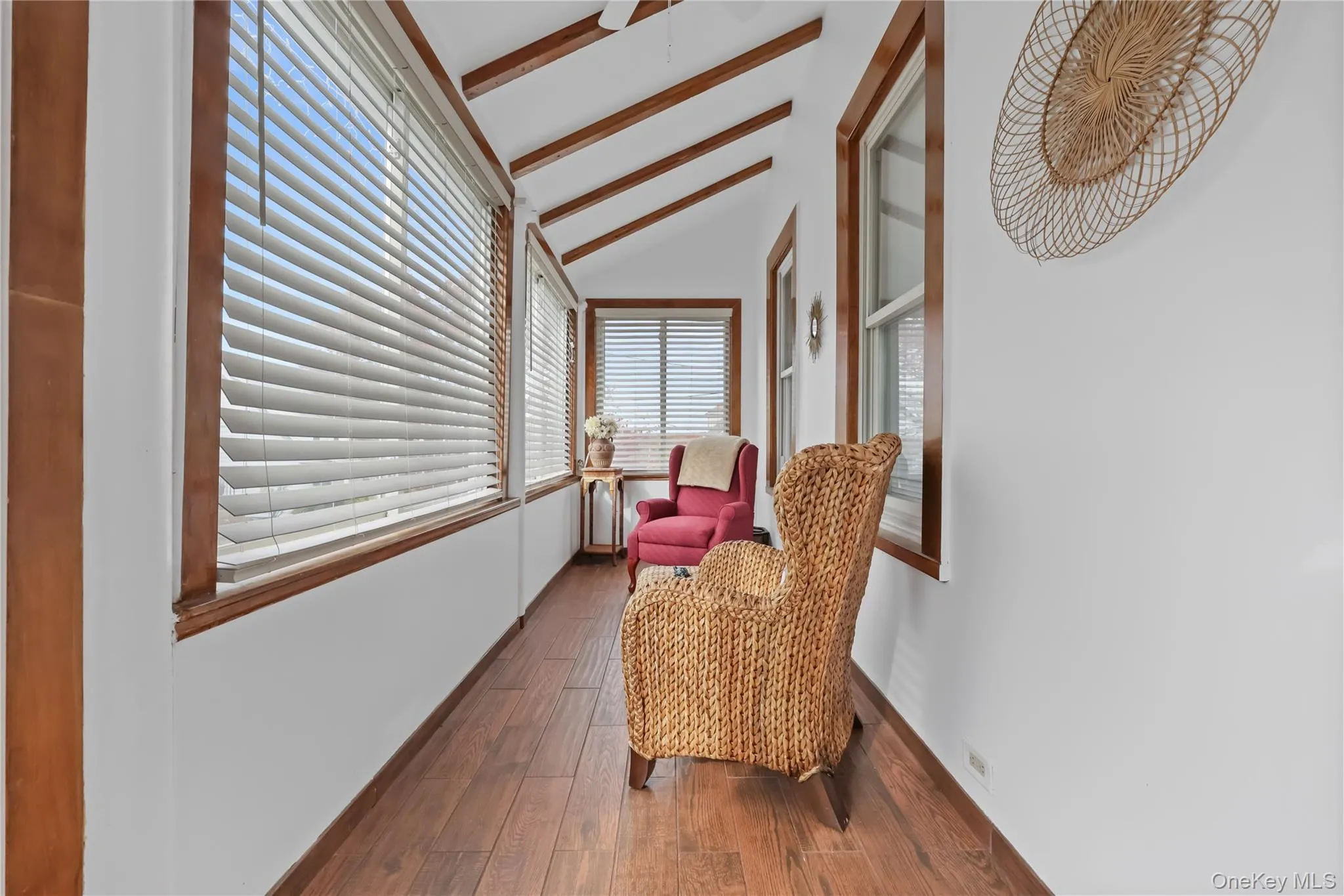 Living area featuring dark wood-style floors and baseboards Living area featuring dark wood-style floors and baseboards