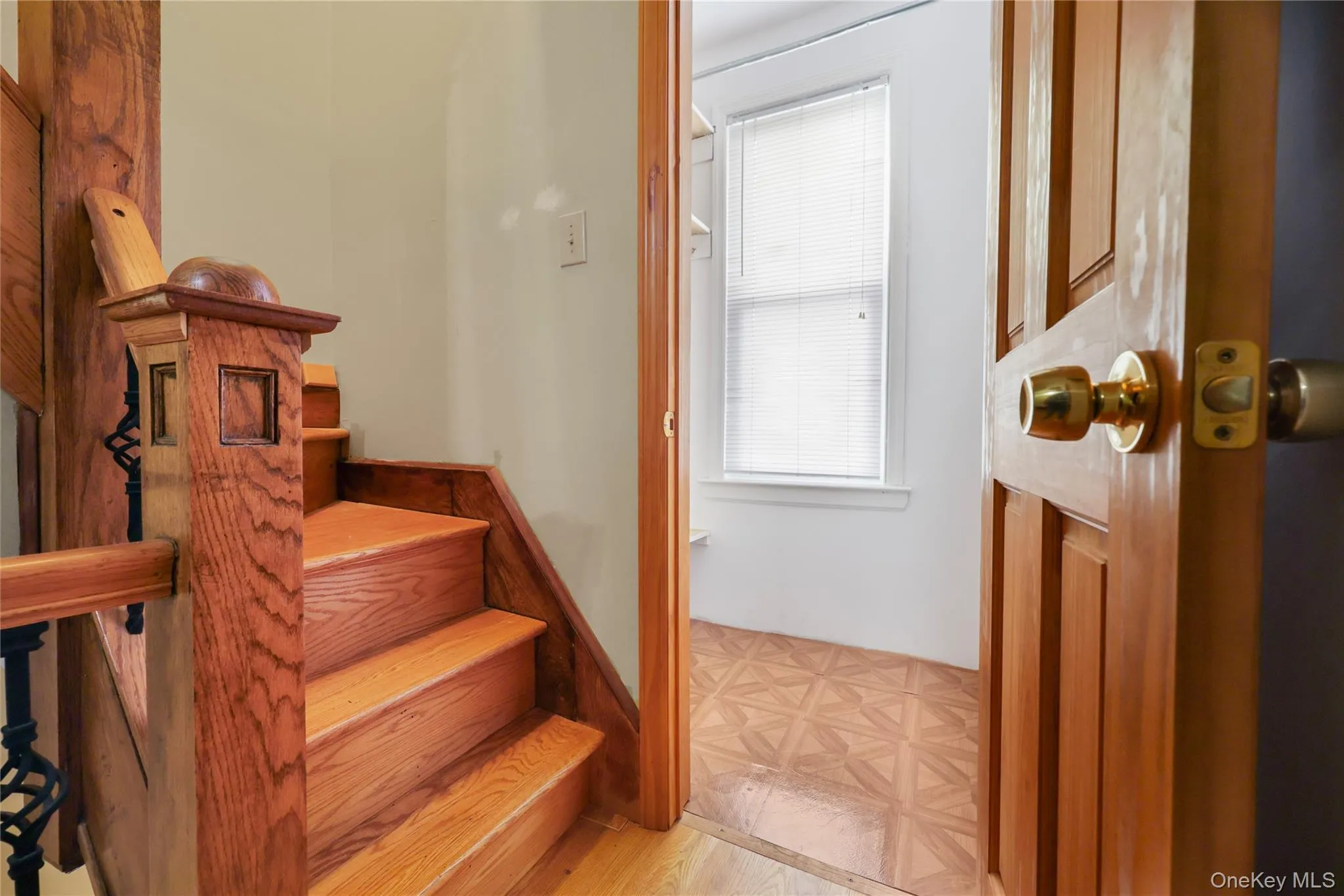 Staircase featuring parquet flooring Staircase featuring parquet flooring