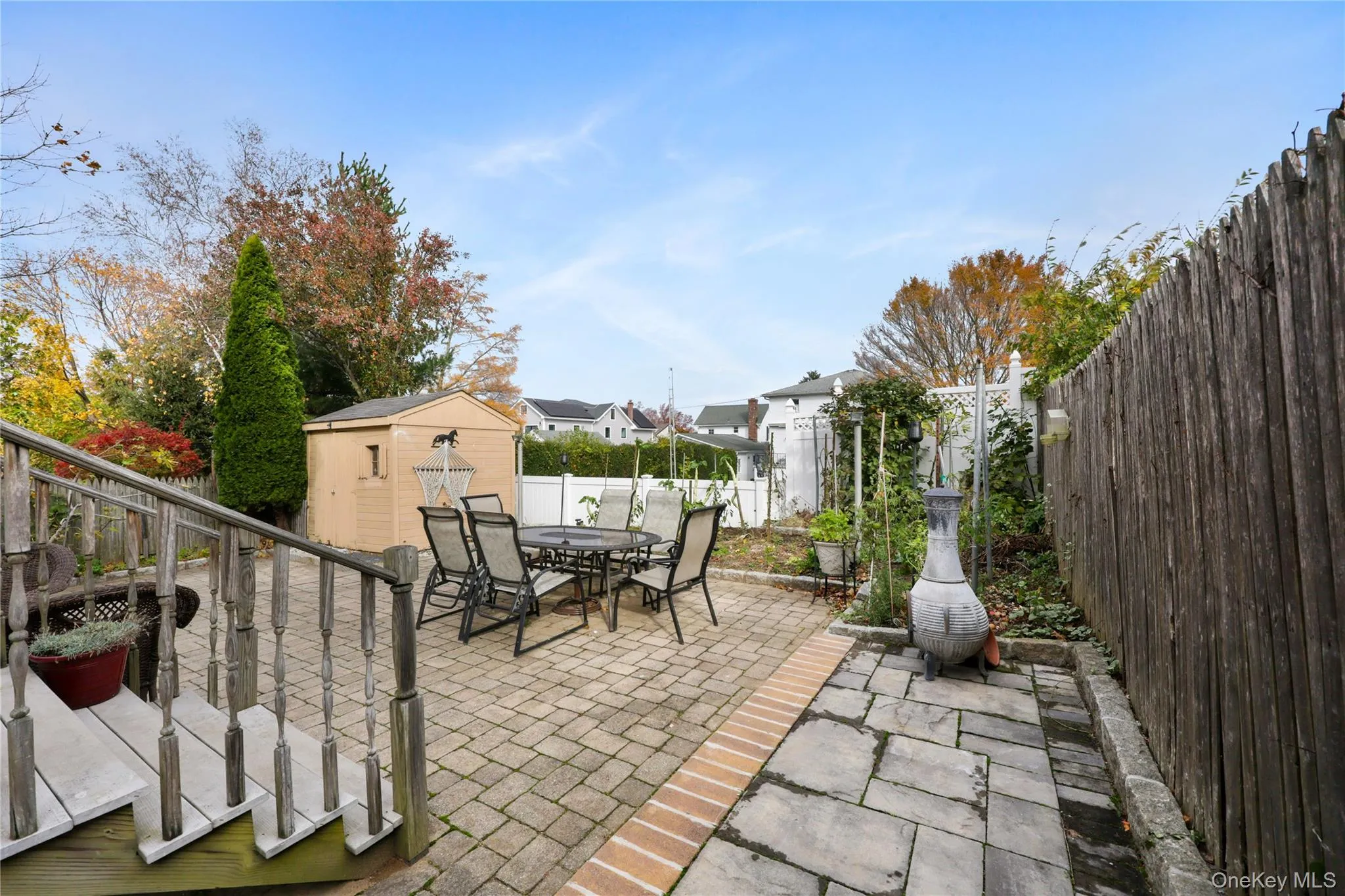 Fenced backyard featuring outdoor dining space, a patio area, and a shed Fenced backyard featuring outdoor dining space, a patio area, and a shed