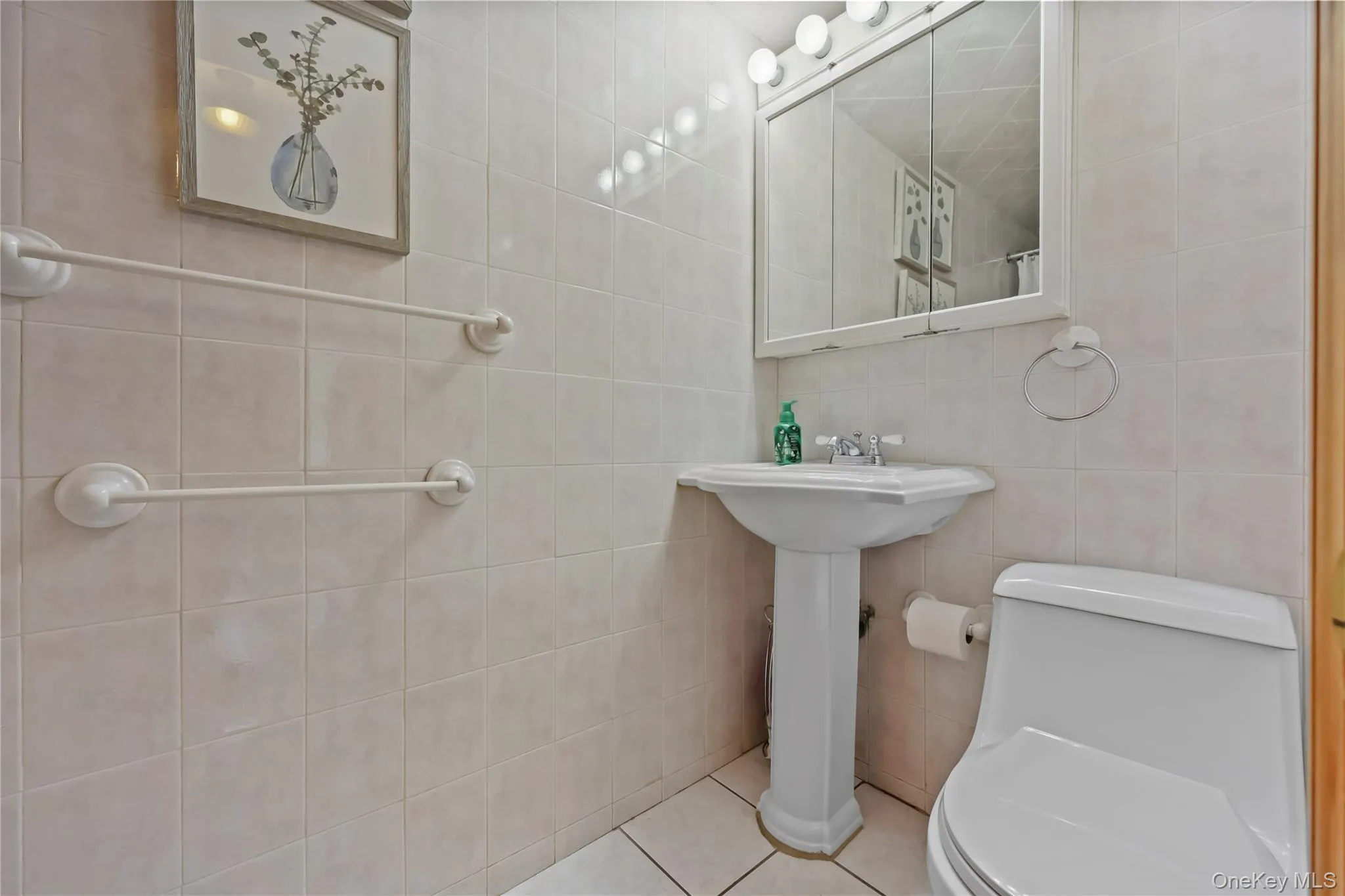 Full bath featuring tile patterned flooring and tile walls Full bath featuring tile patterned flooring and tile walls