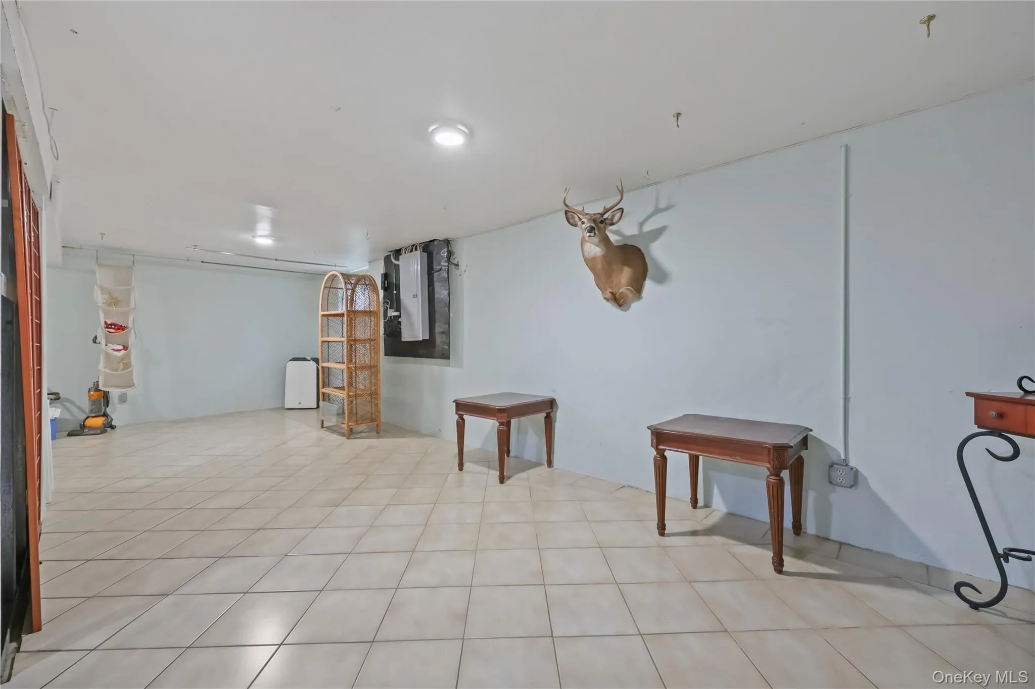 Finished basement featuring light tile patterned floors Finished basement featuring light tile patterned floors