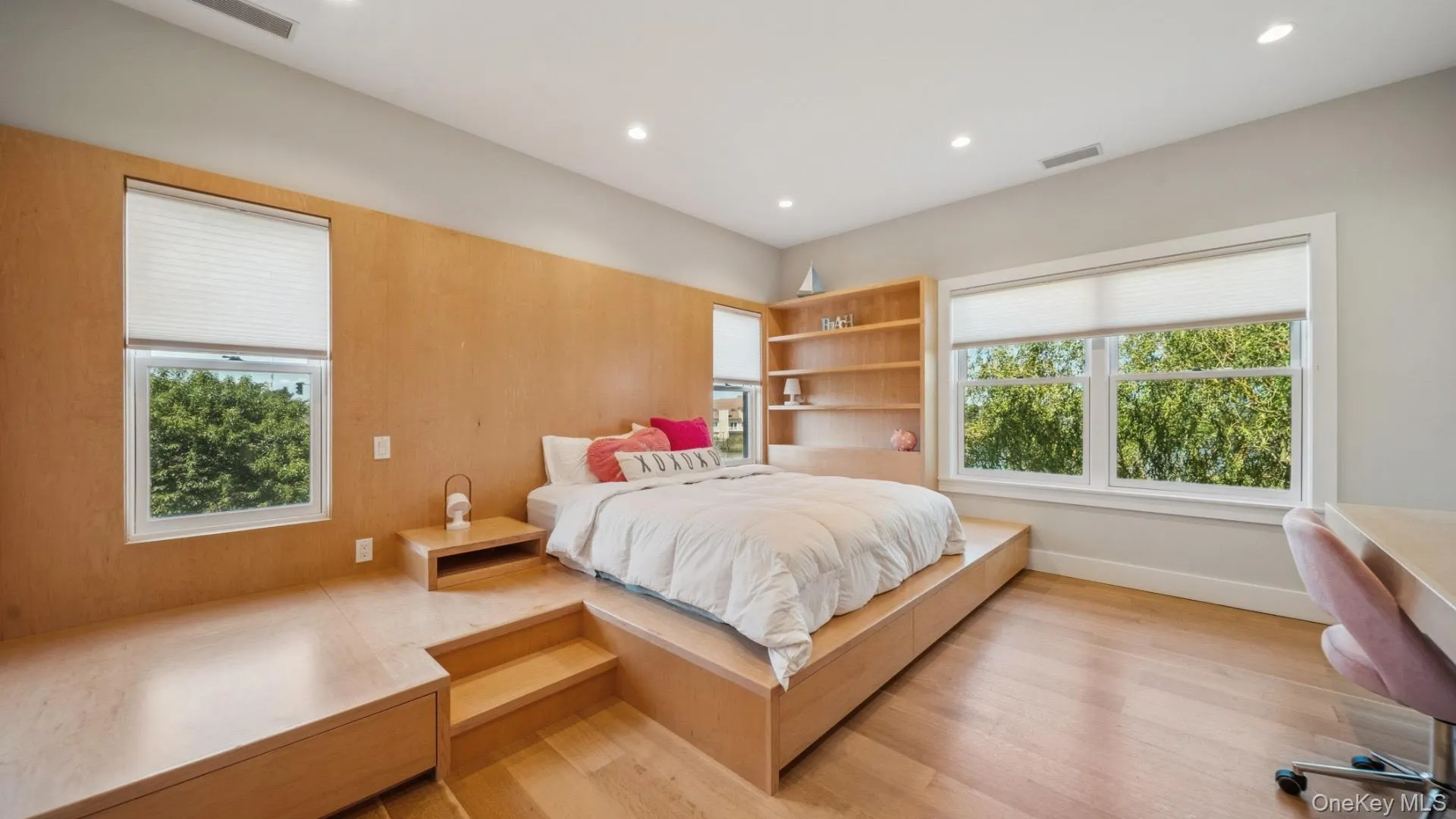 Bedroom with a desk, recessed lighting, multiple windows, and light wood-type flooring Bedroom with a desk, recessed lighting, multiple windows, and light wood-type flooring