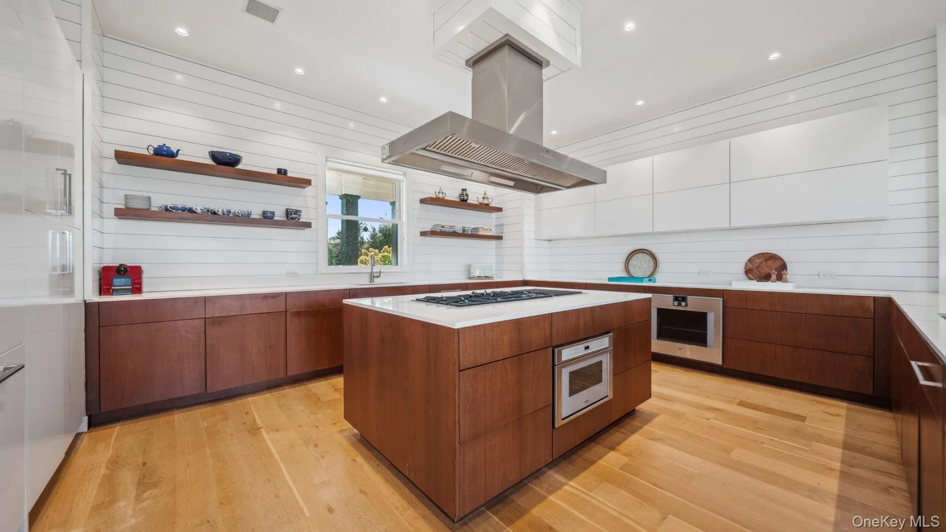 Kitchen featuring open shelves, modern cabinets, island range hood, brown cabinets, and recessed lighting Kitchen featuring open shelves, modern cabinets, island range hood, brown cabinets, and recessed lighting