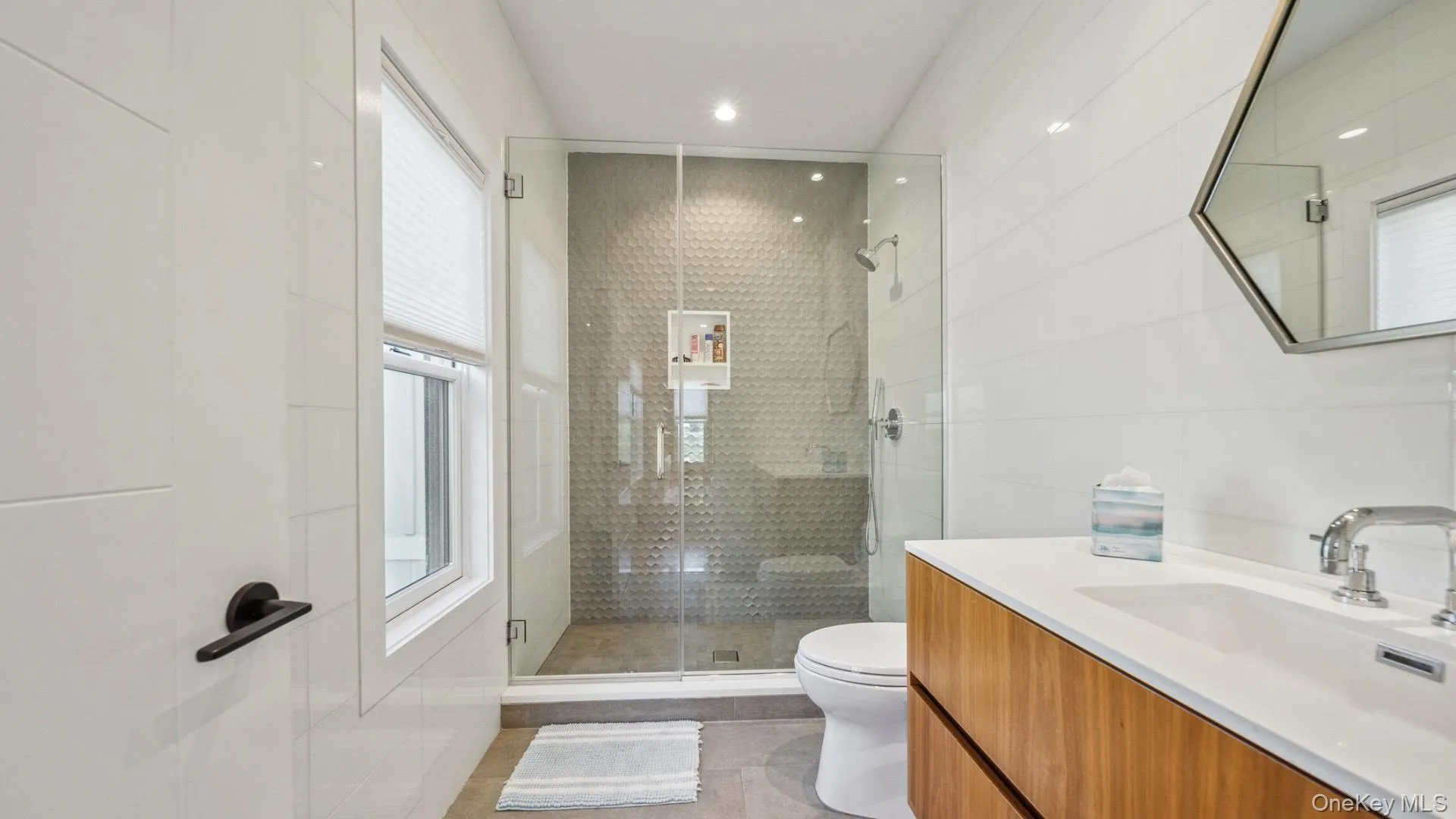 Full bath featuring vanity, a stall shower, light tile patterned floors, and recessed lighting Full bath featuring vanity, a stall shower, light tile patterned floors, and recessed lighting