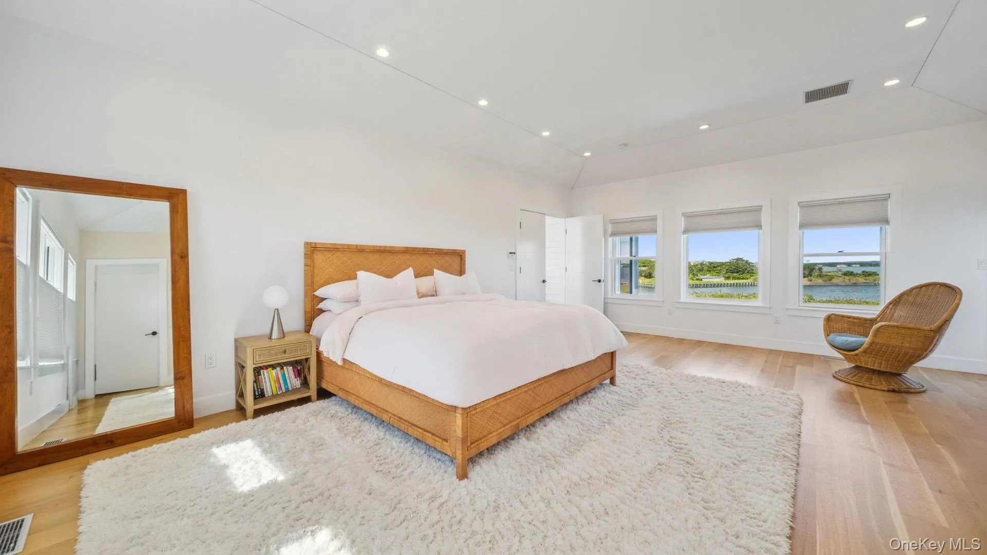 Bedroom with light wood-style floors, recessed lighting, and high vaulted ceiling Bedroom with light wood-style floors, recessed lighting, and high vaulted ceiling