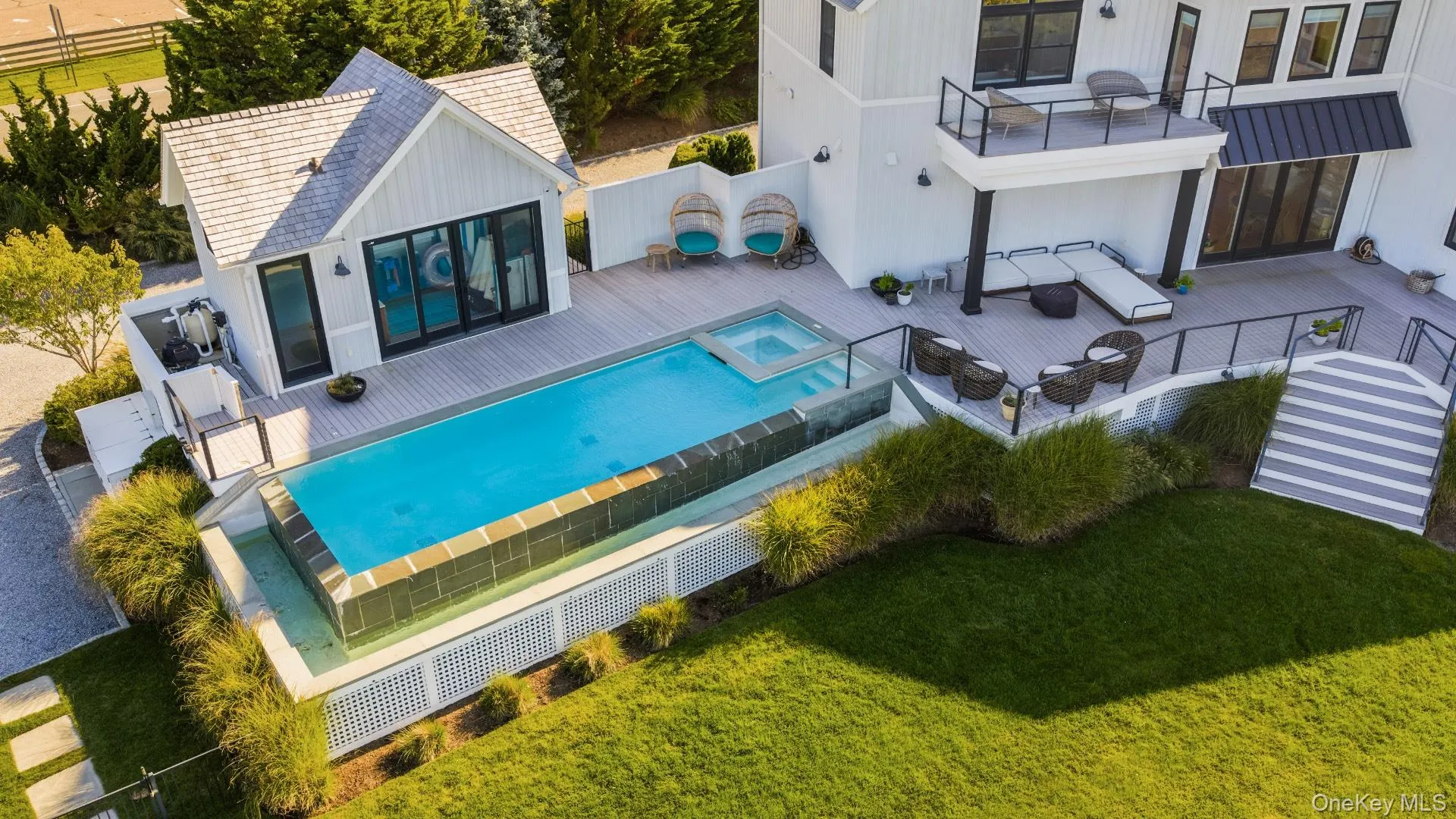 View of swimming pool featuring a patio area, a balcony, a fenced backyard, and a pool with connected hot tub View of swimming pool featuring a patio area, a balcony, a fenced backyard, and a pool with connected hot tub