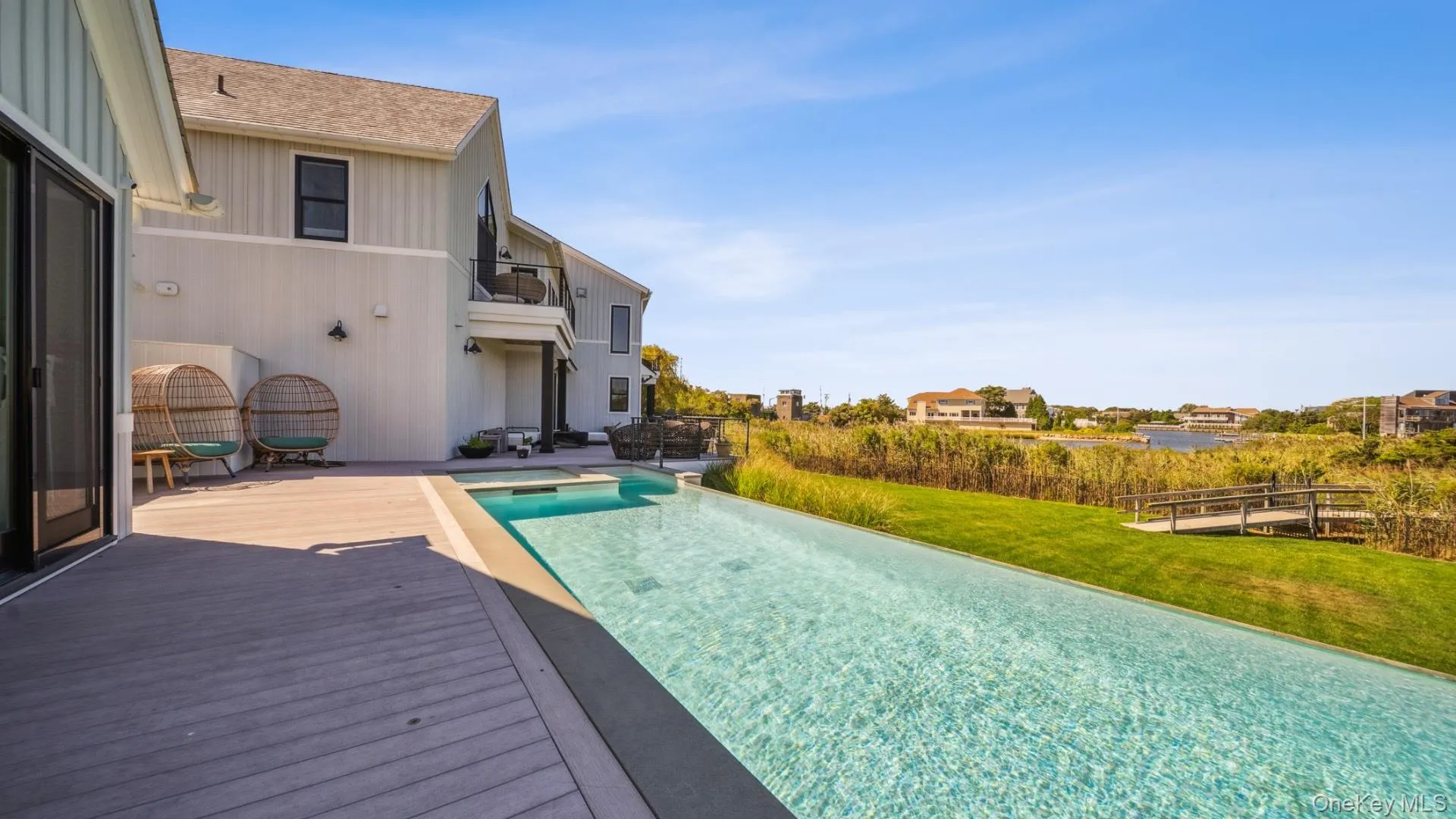 View of pool with a yard, an infinity pool, a balcony, and a patio View of pool with a yard, an infinity pool, a balcony, and a patio