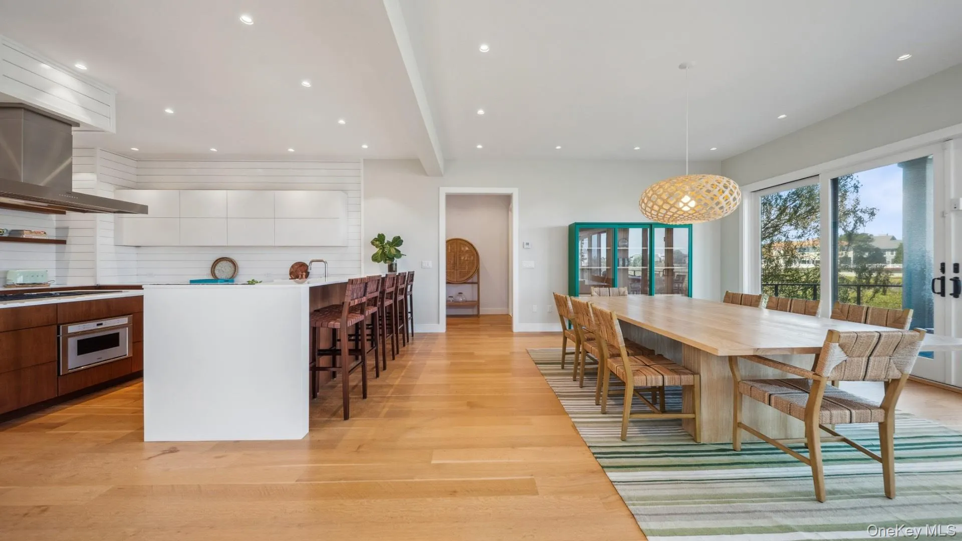 Dining space featuring light wood-style floors, beamed ceiling, recessed lighting, and french doors Dining space featuring light wood-style floors, beamed ceiling, recessed lighting, and french doors