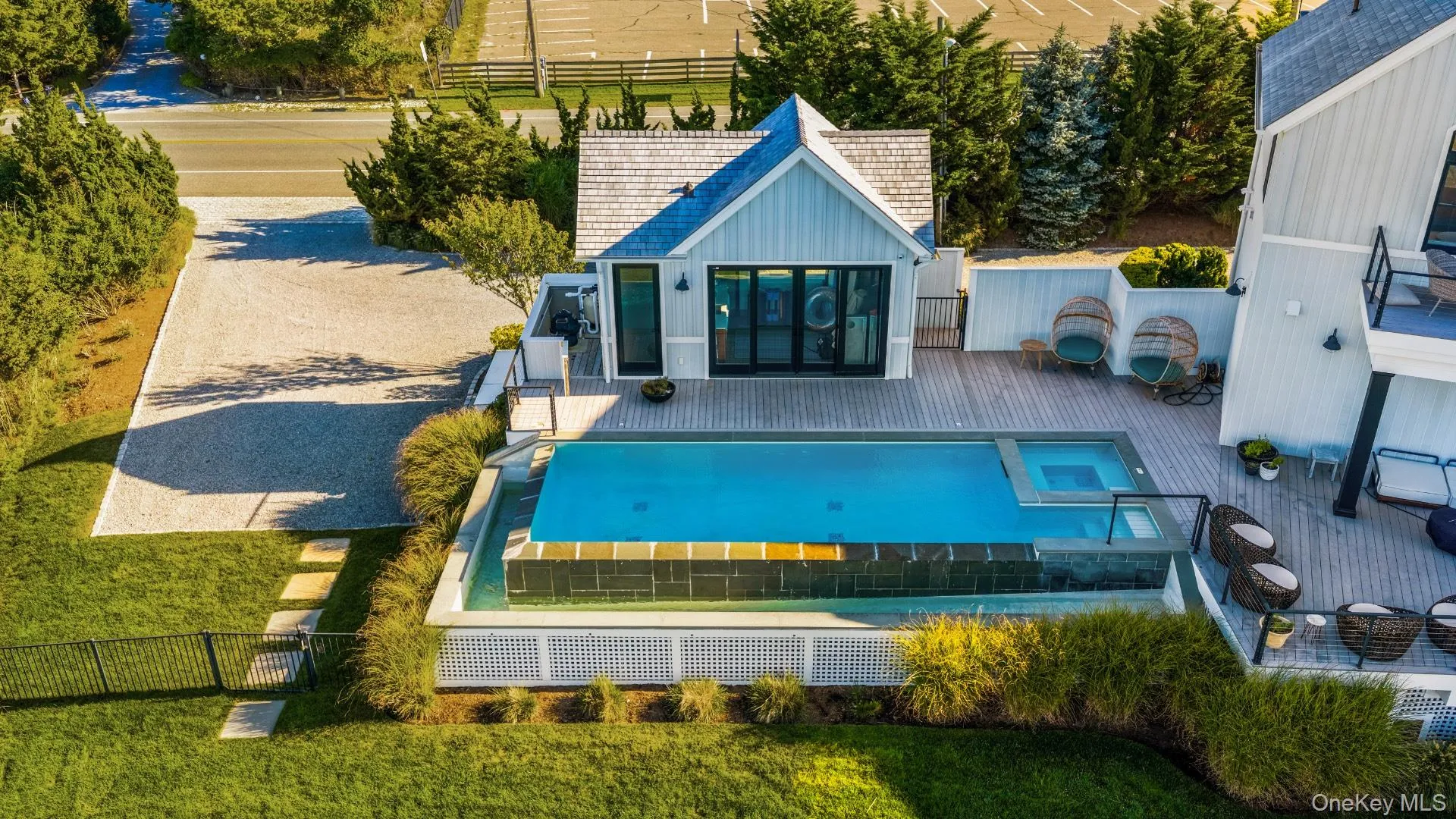 Back of house with a patio and a pool with connected hot tub Back of house with a patio and a pool with connected hot tub