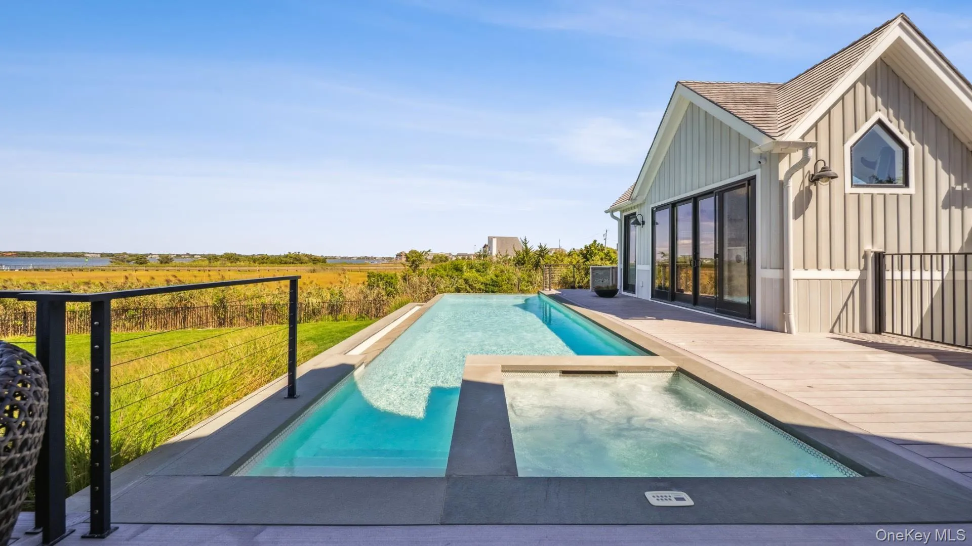View of pool featuring a pool with connected hot tub and a view of countryside View of pool featuring a pool with connected hot tub and a view of countryside