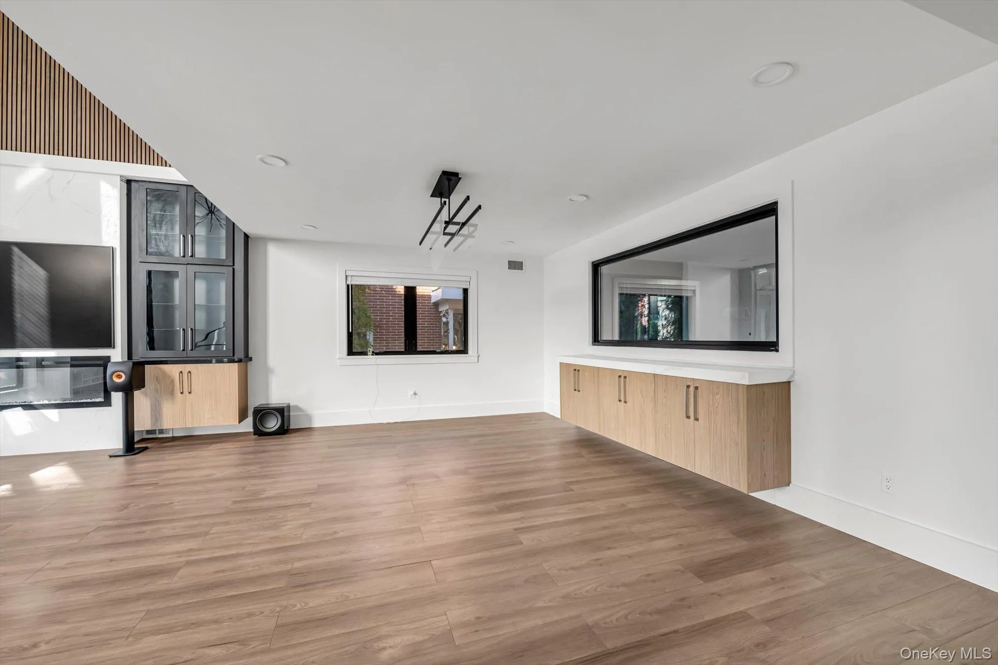 Unfurnished living room featuring light wood-type flooring and recessed lighting Unfurnished living room featuring light wood-type flooring and recessed lighting
