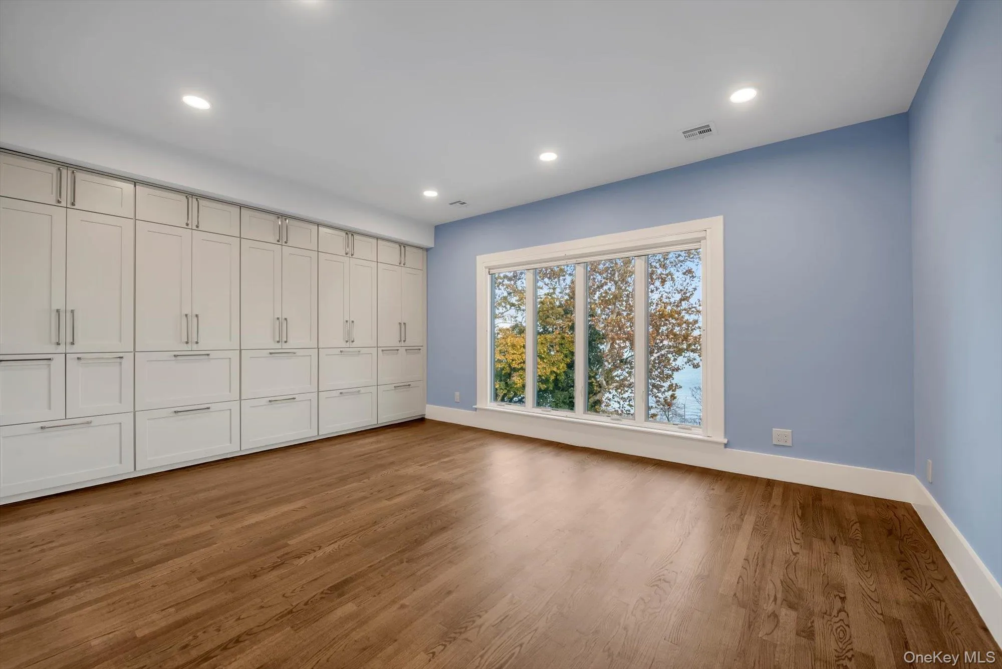 Unfurnished bedroom with light wood-type flooring, recessed lighting, and a closet Unfurnished bedroom with light wood-type flooring, recessed lighting, and a closet