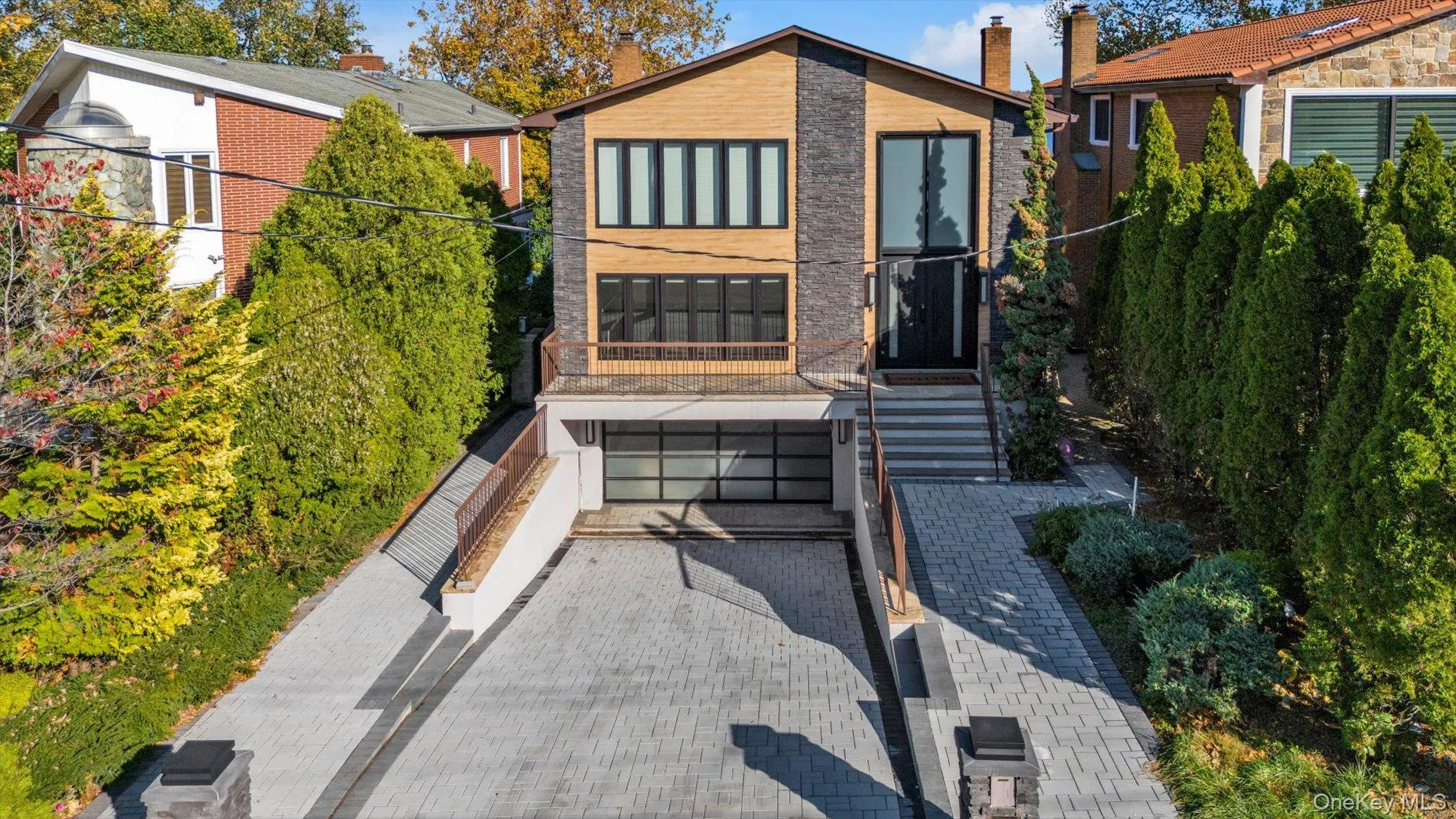 View of front of property with a garage and decorative driveway View of front of property with a garage and decorative driveway