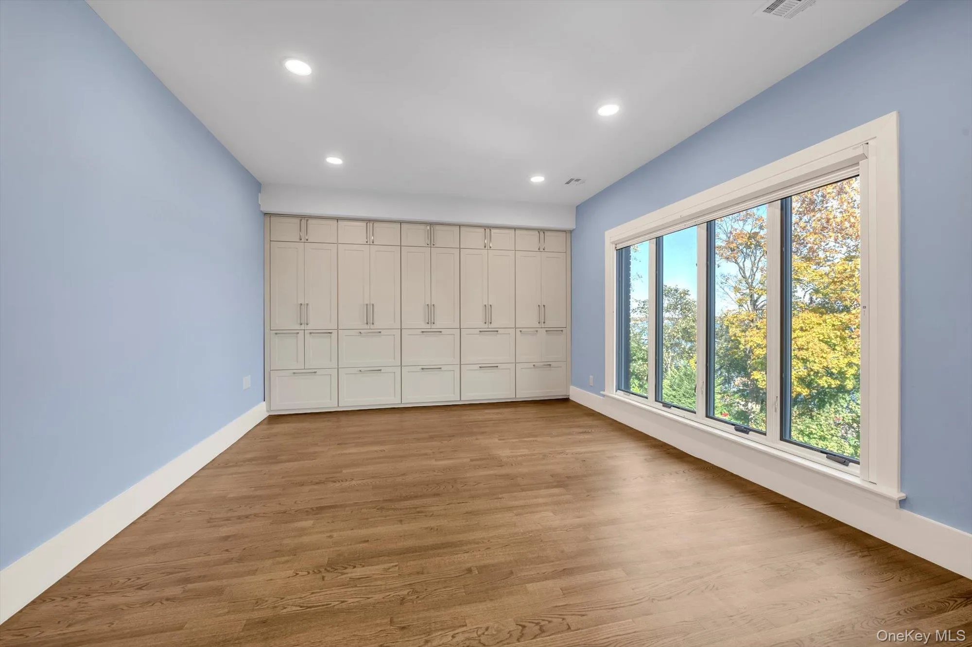 Unfurnished bedroom with recessed lighting, light wood finished floors, and a closet Unfurnished bedroom with recessed lighting, light wood finished floors, and a closet