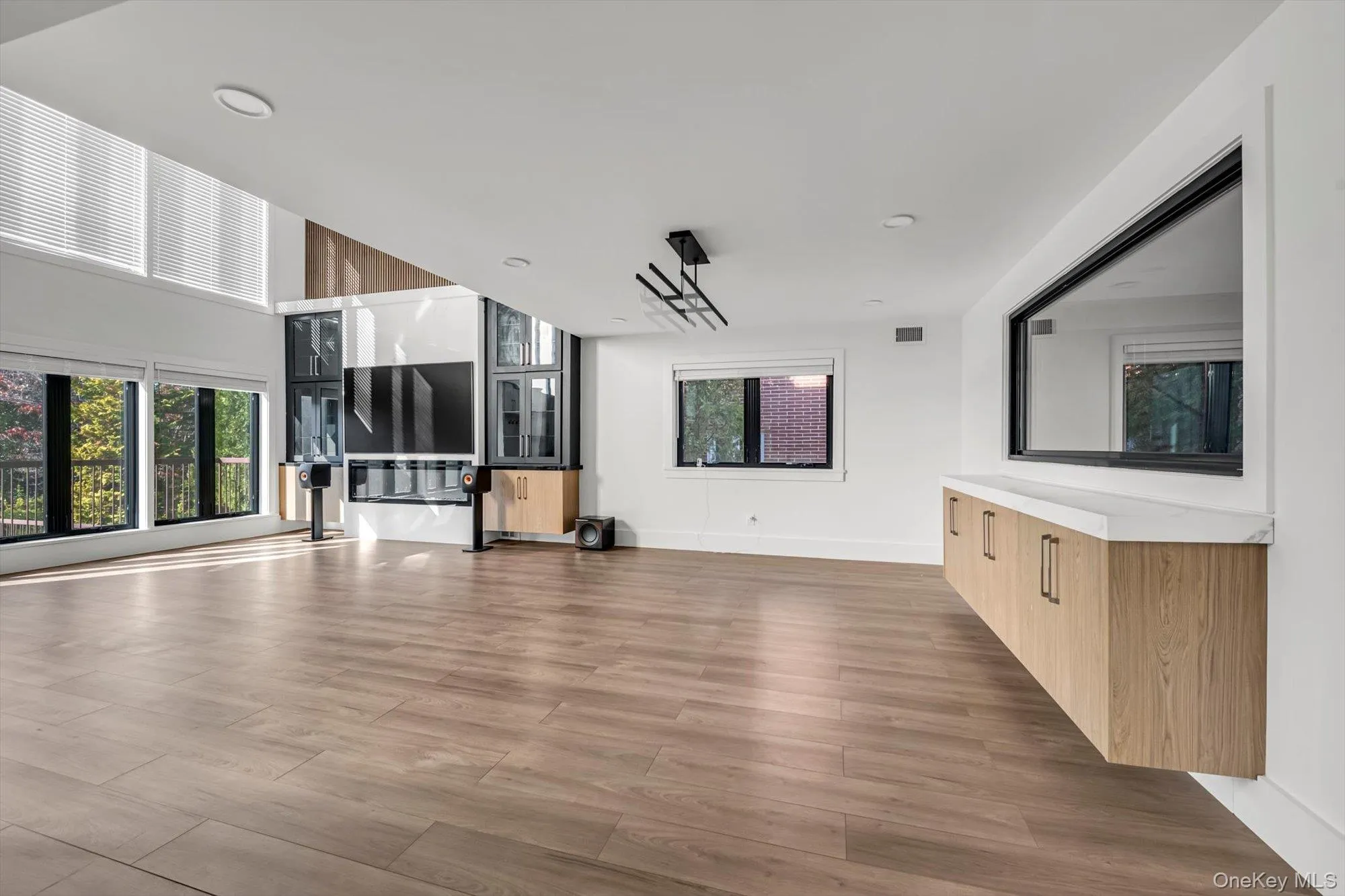 Unfurnished living room with plenty of natural light and light wood-style floors Unfurnished living room with plenty of natural light and light wood-style floors