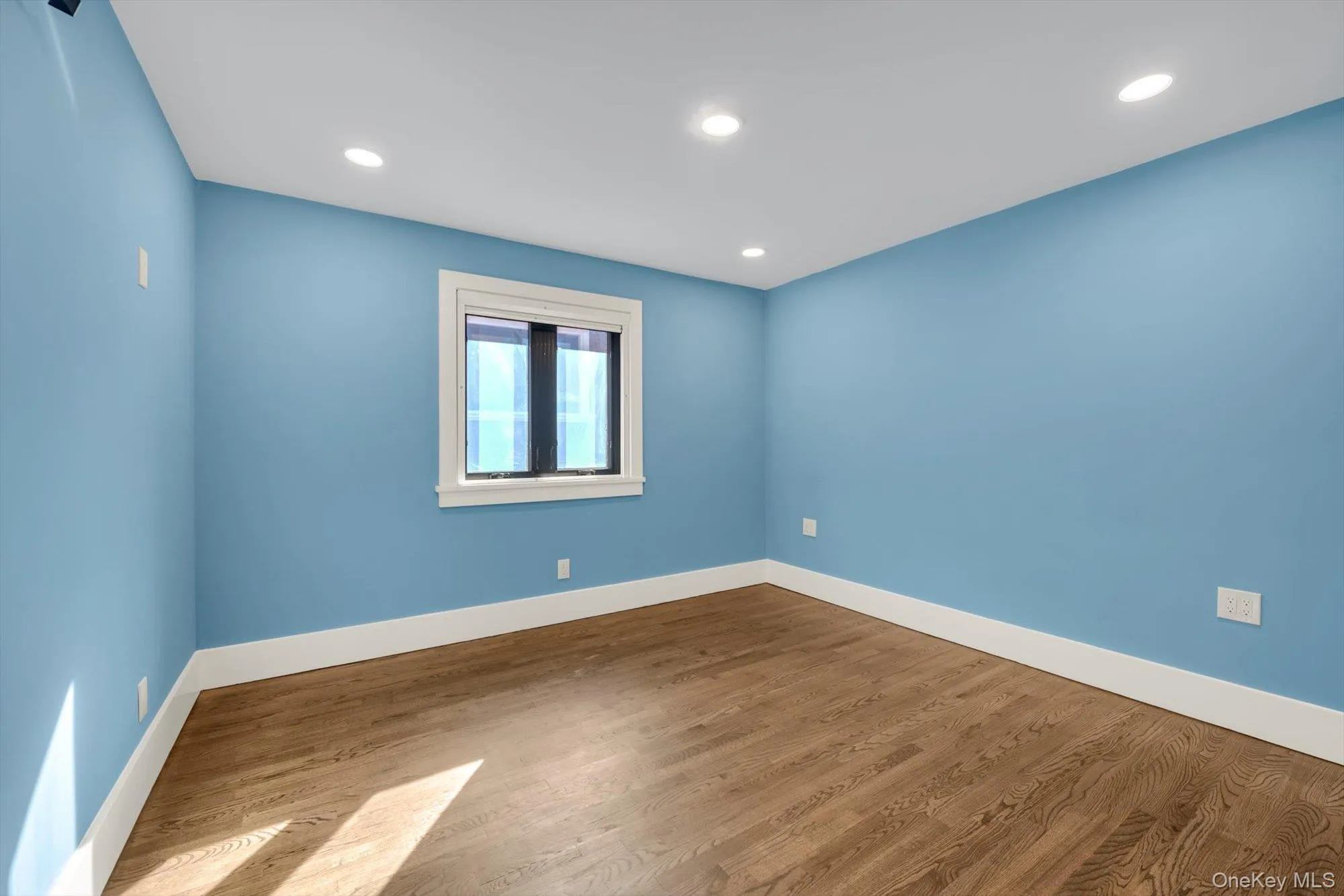 Spare room with wood finished floors and recessed lighting Spare room with wood finished floors and recessed lighting