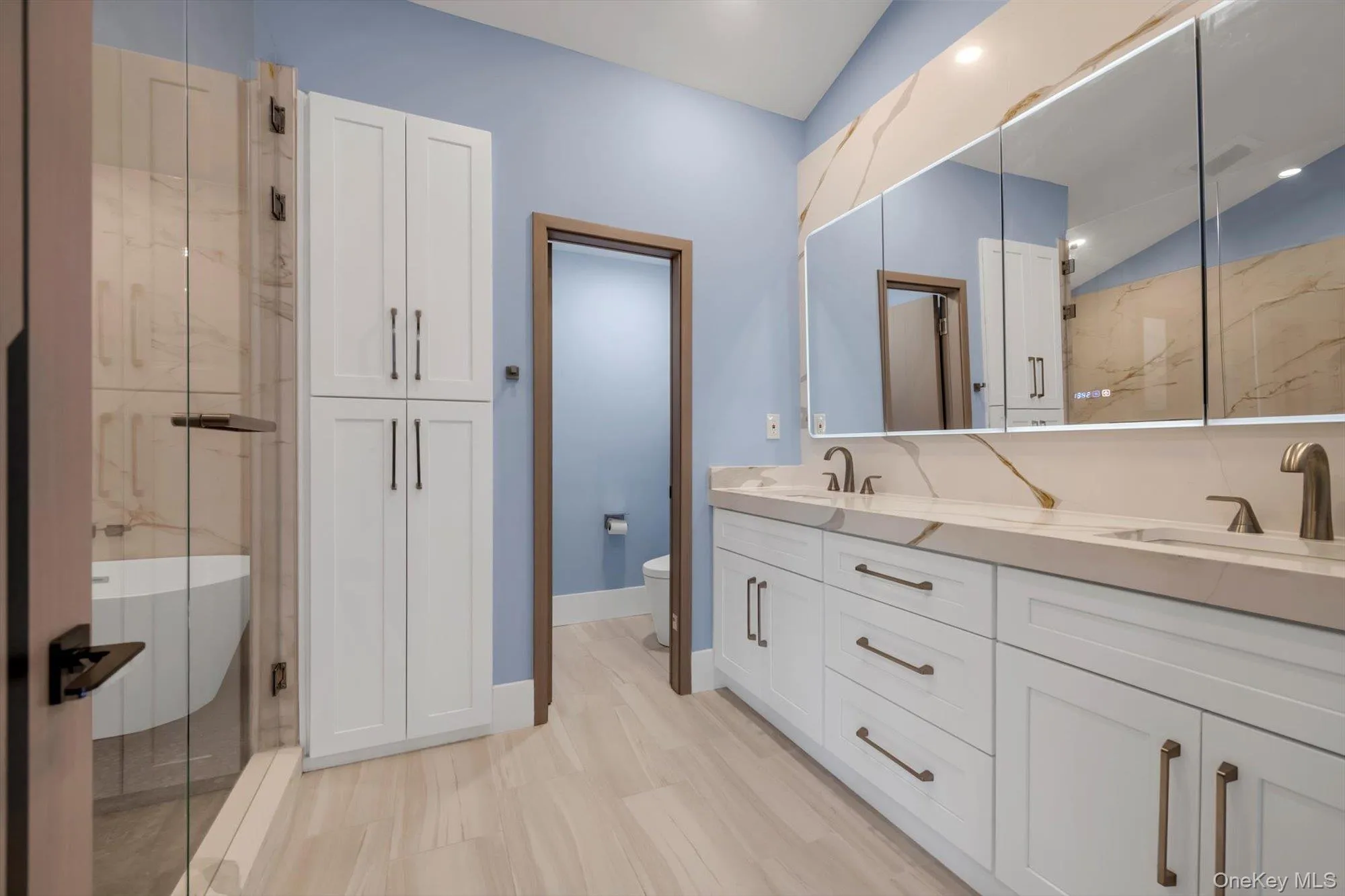 Full bath with double vanity, a marble finish shower, lofted ceiling, a soaking tub, and recessed lighting Full bath with double vanity, a marble finish shower, lofted ceiling, a soaking tub, and recessed lighting