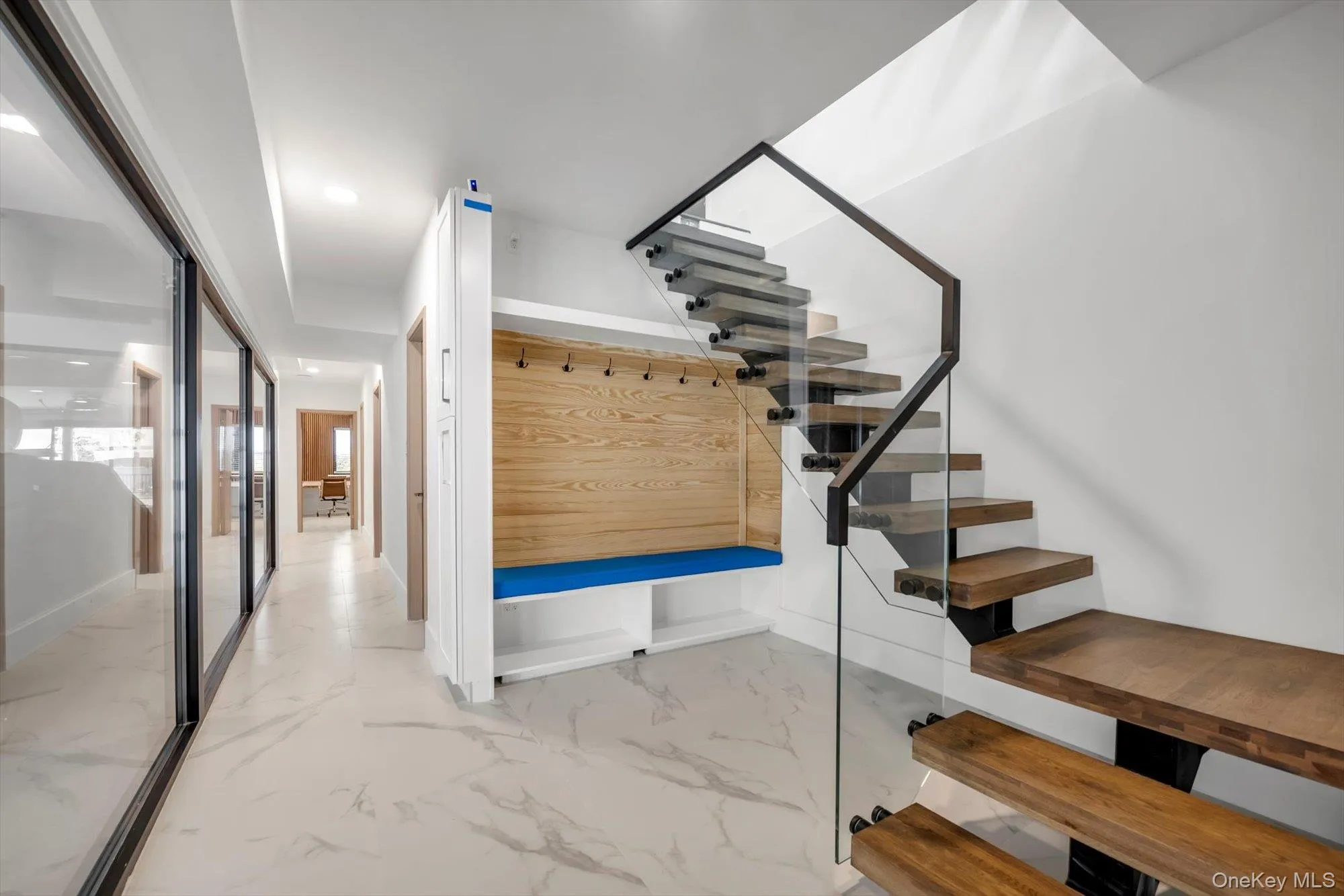 Mudroom featuring light marble finish floors and baseboards Mudroom featuring light marble finish floors and baseboards
