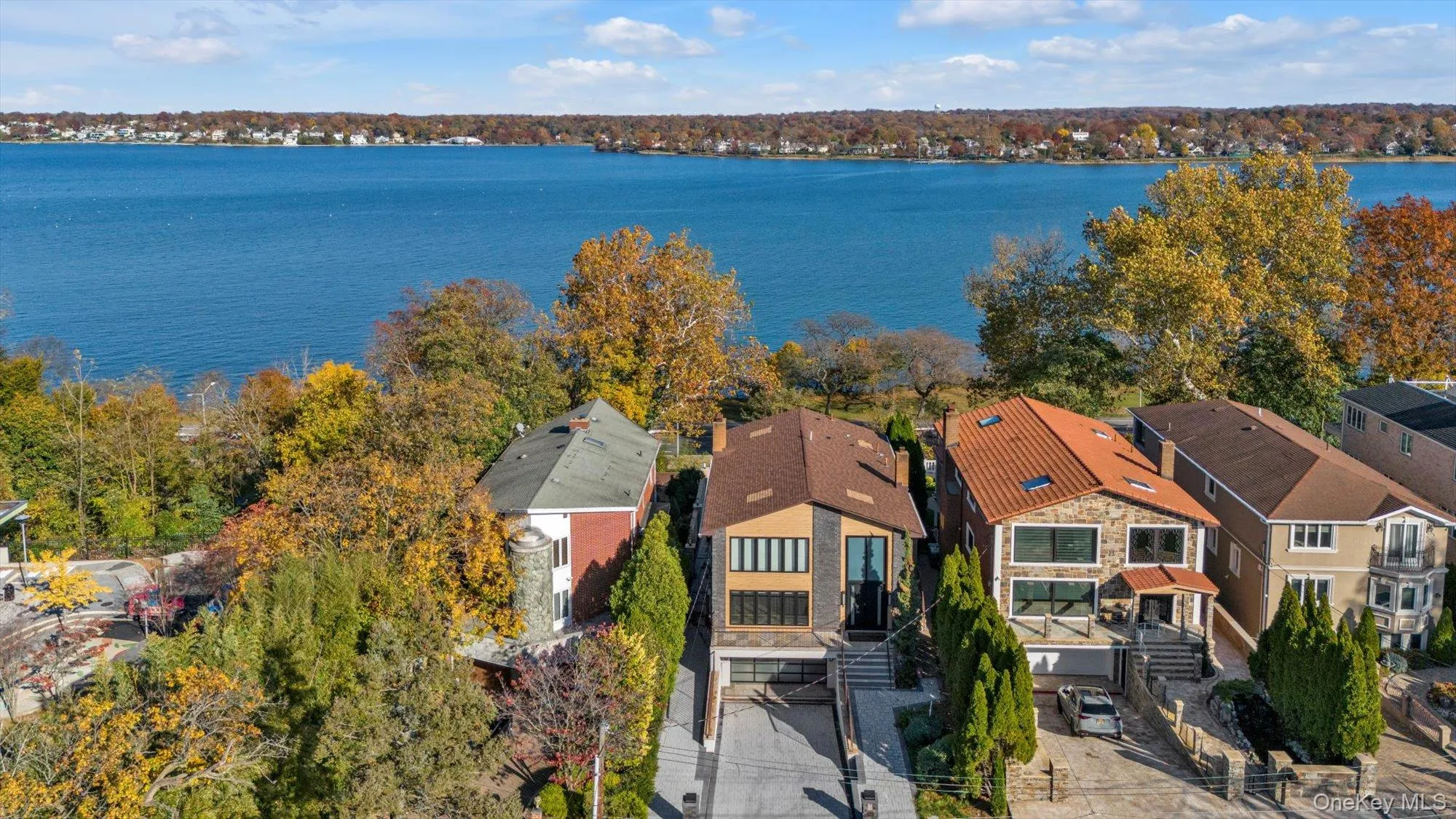 Aerial perspective of suburban area featuring a large body of water Aerial perspective of suburban area featuring a large body of water