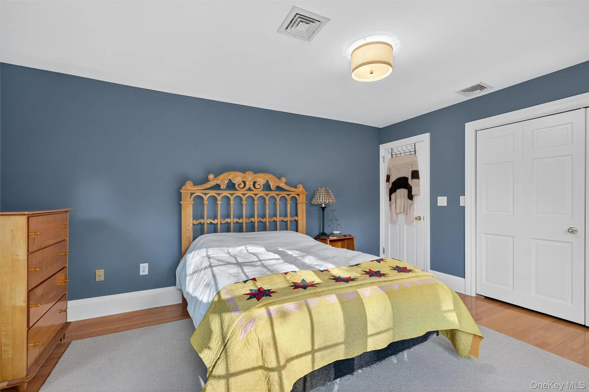 Bedroom with a closet and wood finished floors Bedroom with a closet and wood finished floors