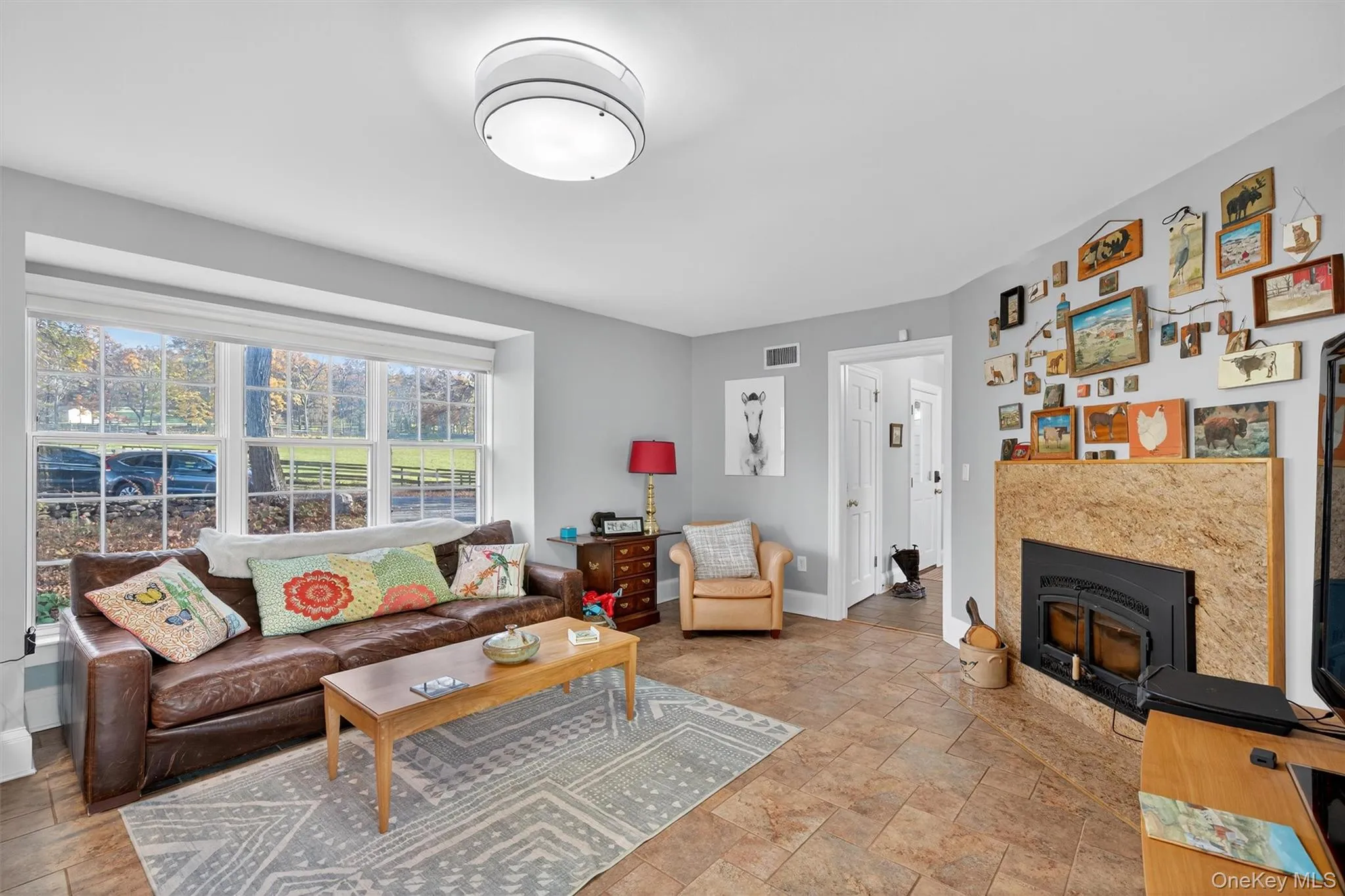 Living room with stone finish floors and baseboards Living room with stone finish floors and baseboards