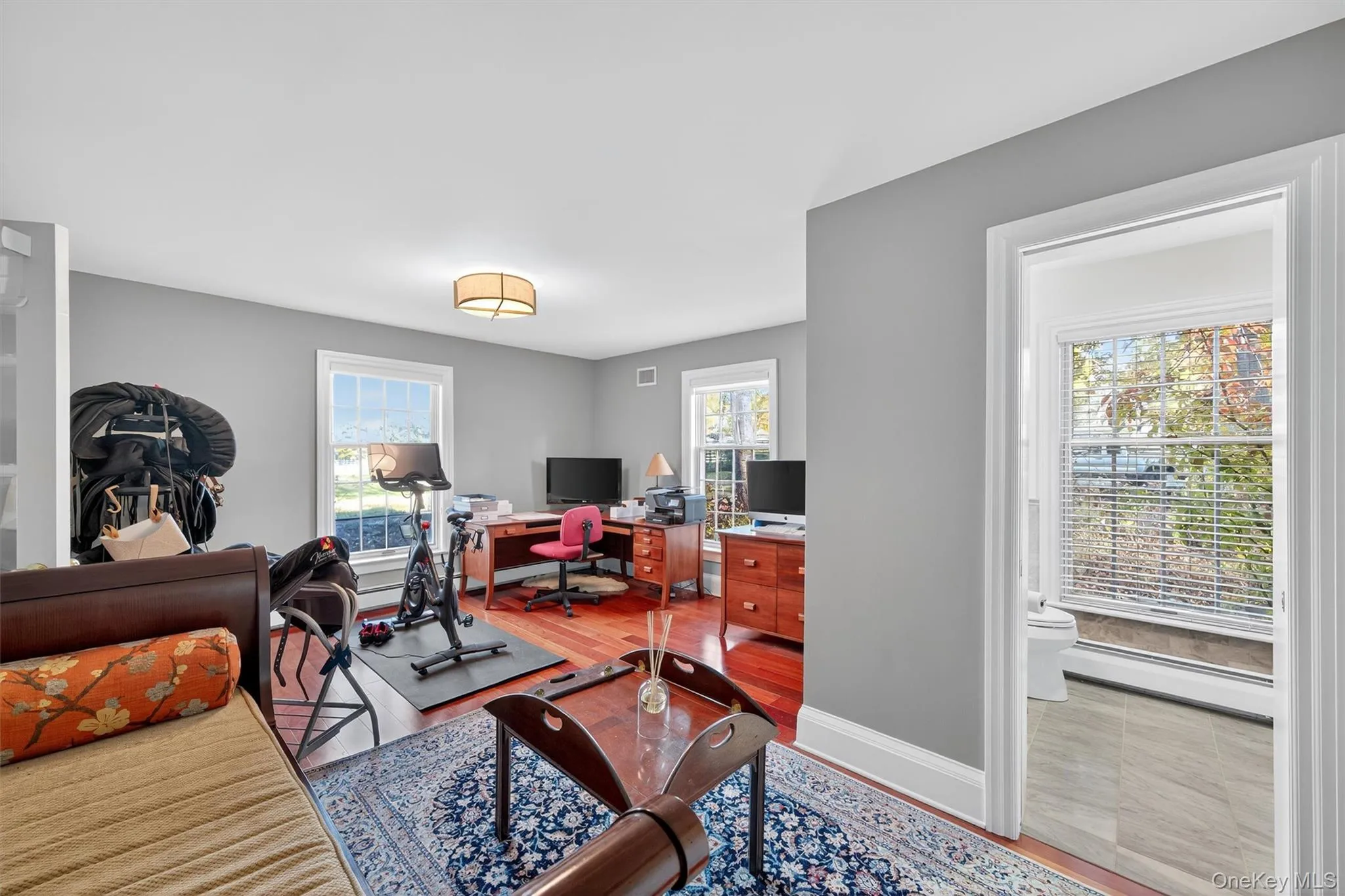 Office with a baseboard heating unit, plenty of natural light, and light wood-type flooring Office with a baseboard heating unit, plenty of natural light, and light wood-type flooring