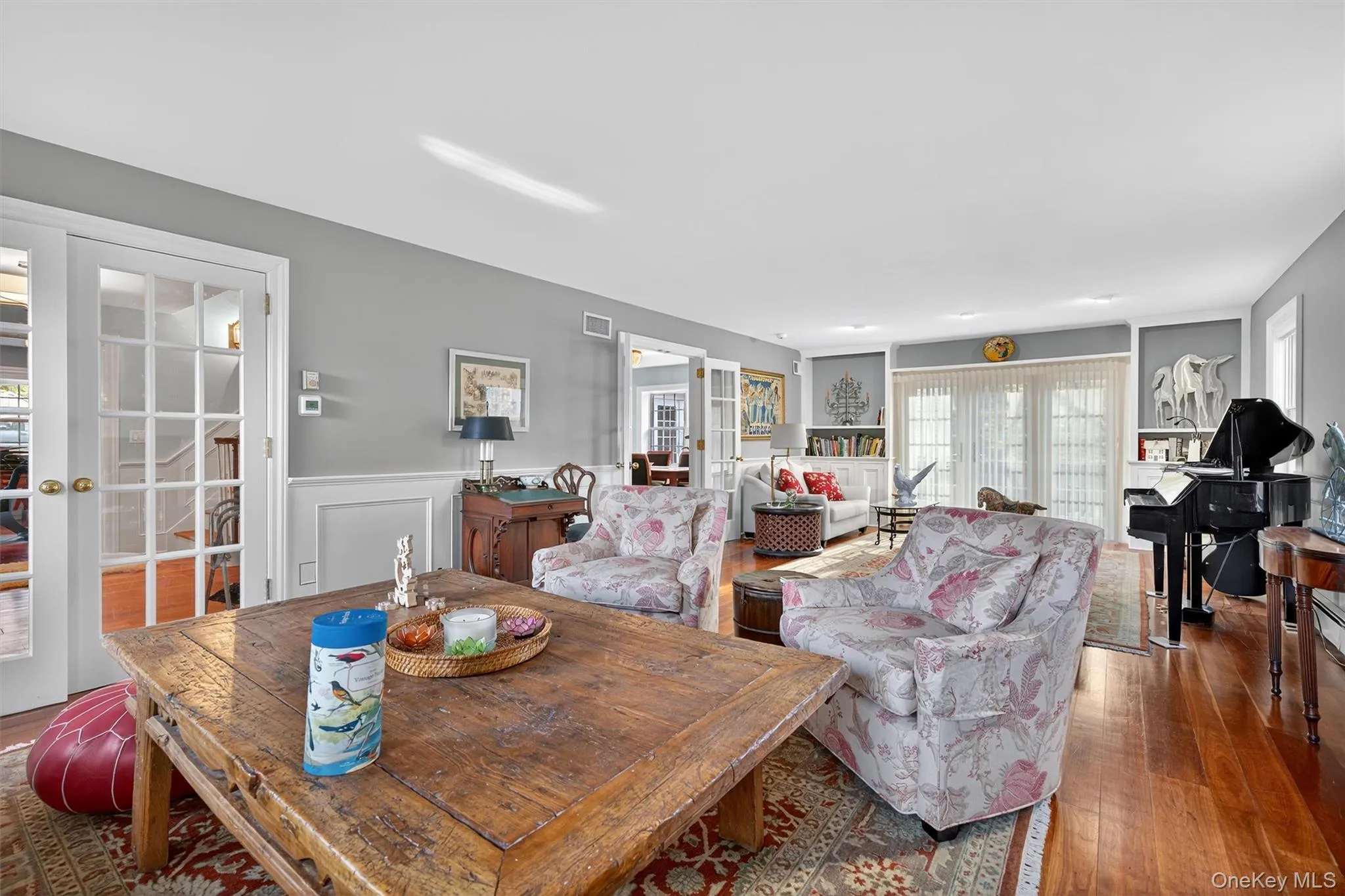 Dining space with french doors, hardwood / wood-style flooring, and wainscoting Dining space with french doors, hardwood / wood-style flooring, and wainscoting
