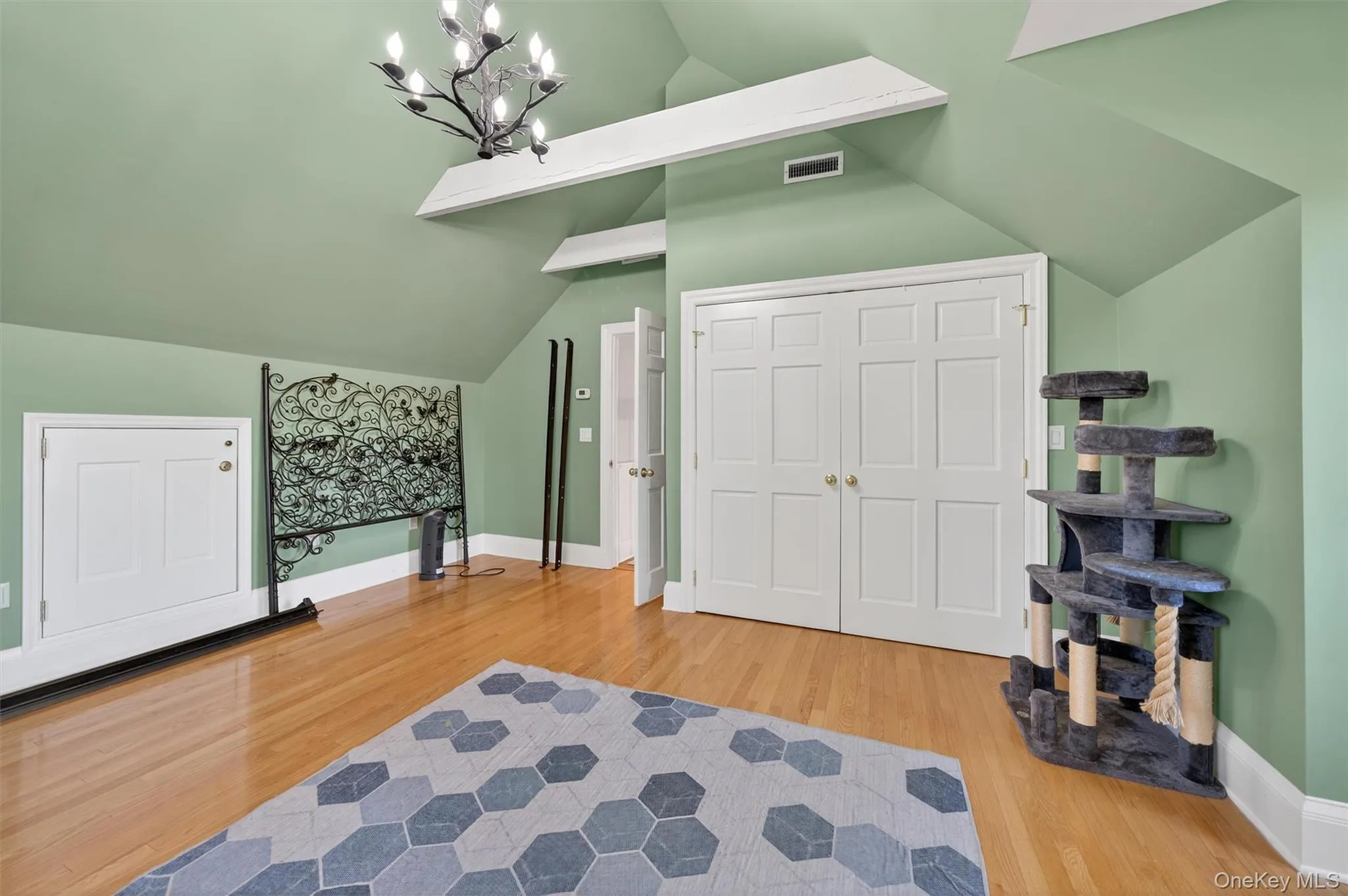 Bonus room with light wood-type flooring and a chandelier Bonus room with light wood-type flooring and a chandelier