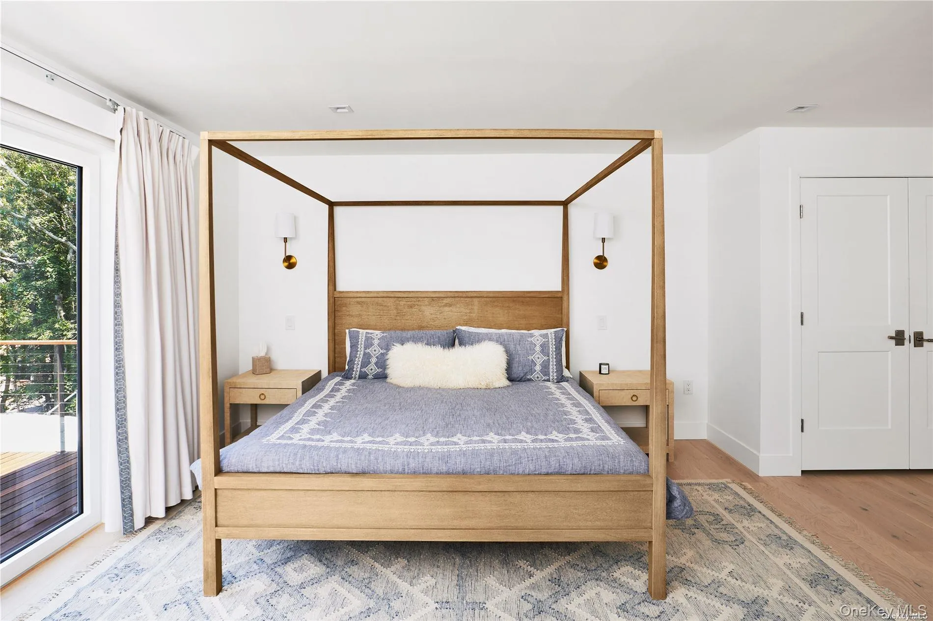 Primary bedroom with private deck and water views, 2 walk-in closets Primary bedroom with private deck and water views, 2 walk-in closets