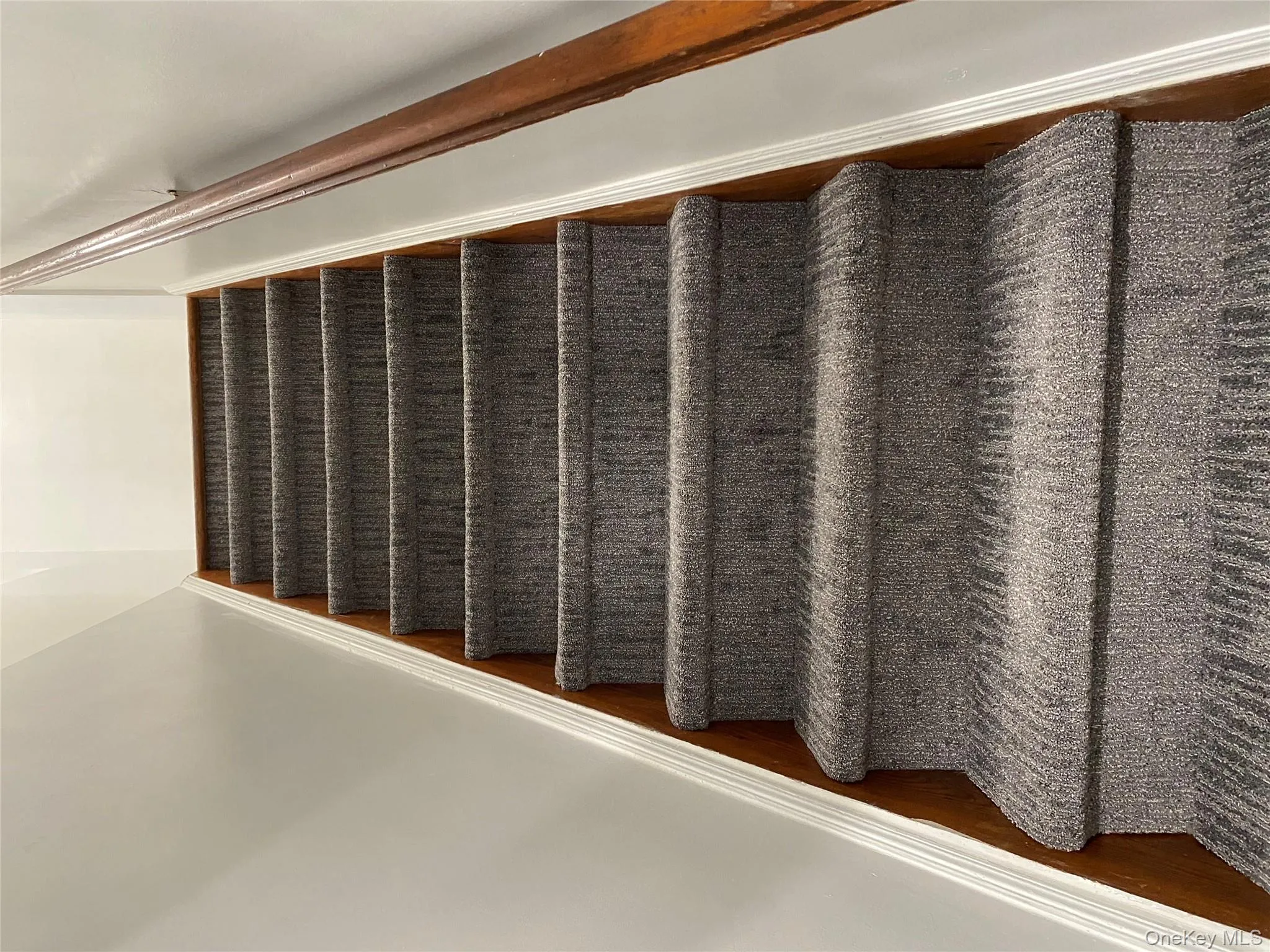 Staircase featuring baseboards Staircase featuring baseboards