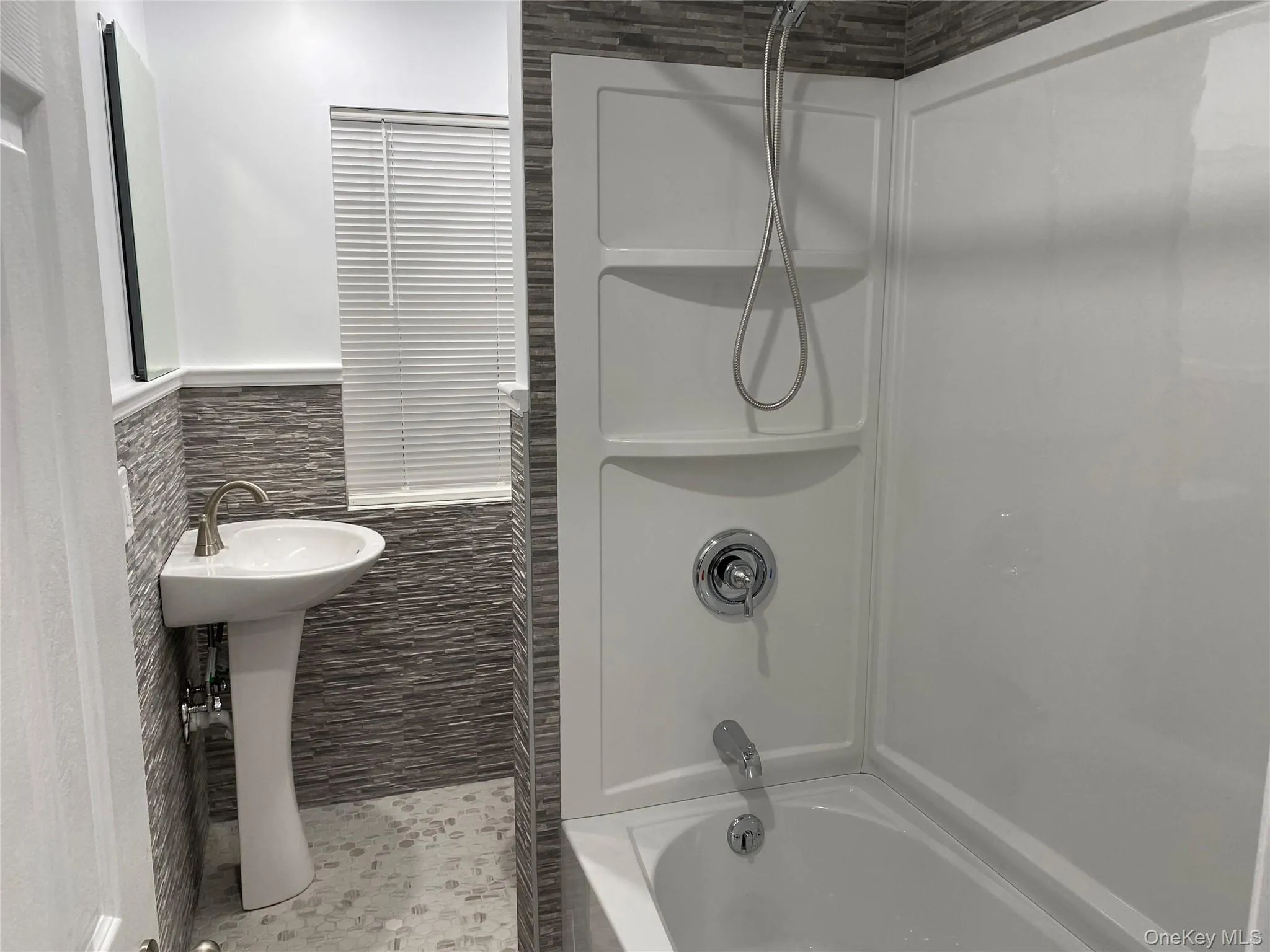 Bathroom with tile walls and washtub / shower combination Bathroom with tile walls and washtub / shower combination