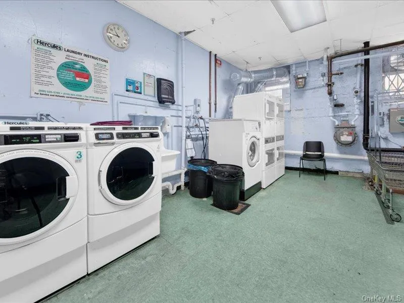 Shared laundry featuring a paneled ceiling and washing machine and dryer Shared laundry featuring a paneled ceiling and washing machine and dryer