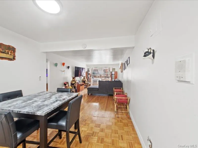 Dining area featuring baseboards and parquet flooring Dining area featuring baseboards and parquet flooring