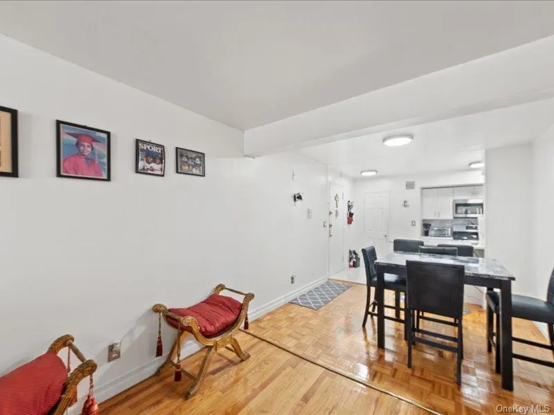 Dining room featuring baseboards and parquet floors Dining room featuring baseboards and parquet floors