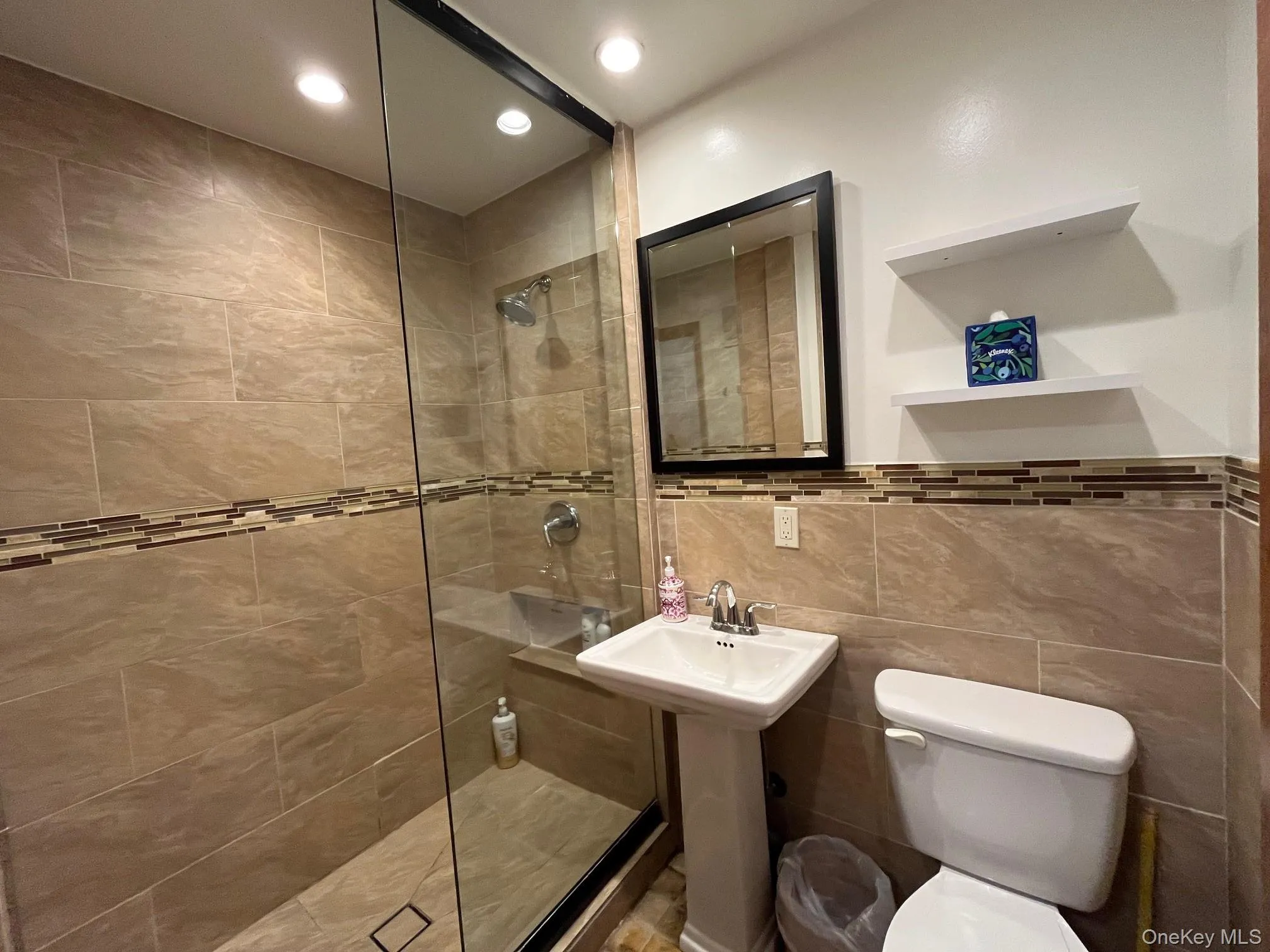 Bathroom featuring walk in shower, tile walls, and recessed lighting Bathroom featuring walk in shower, tile walls, and recessed lighting
