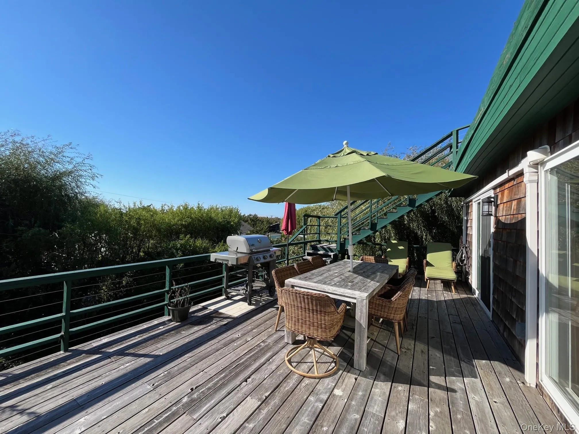 Deck with outdoor dining area and grilling area Deck with outdoor dining area and grilling area