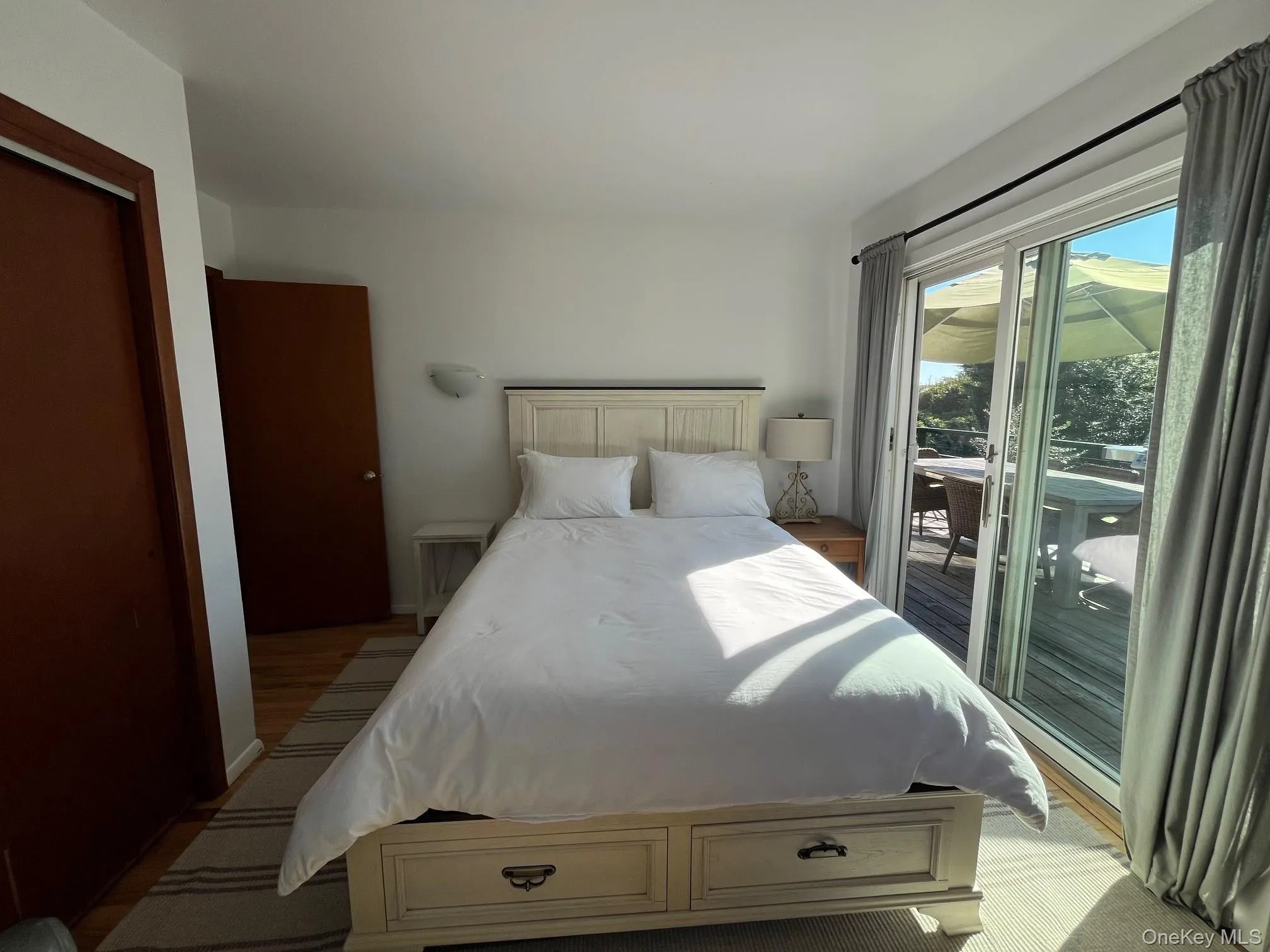 Bedroom with access to exterior and light wood-type flooring Bedroom with access to exterior and light wood-type flooring