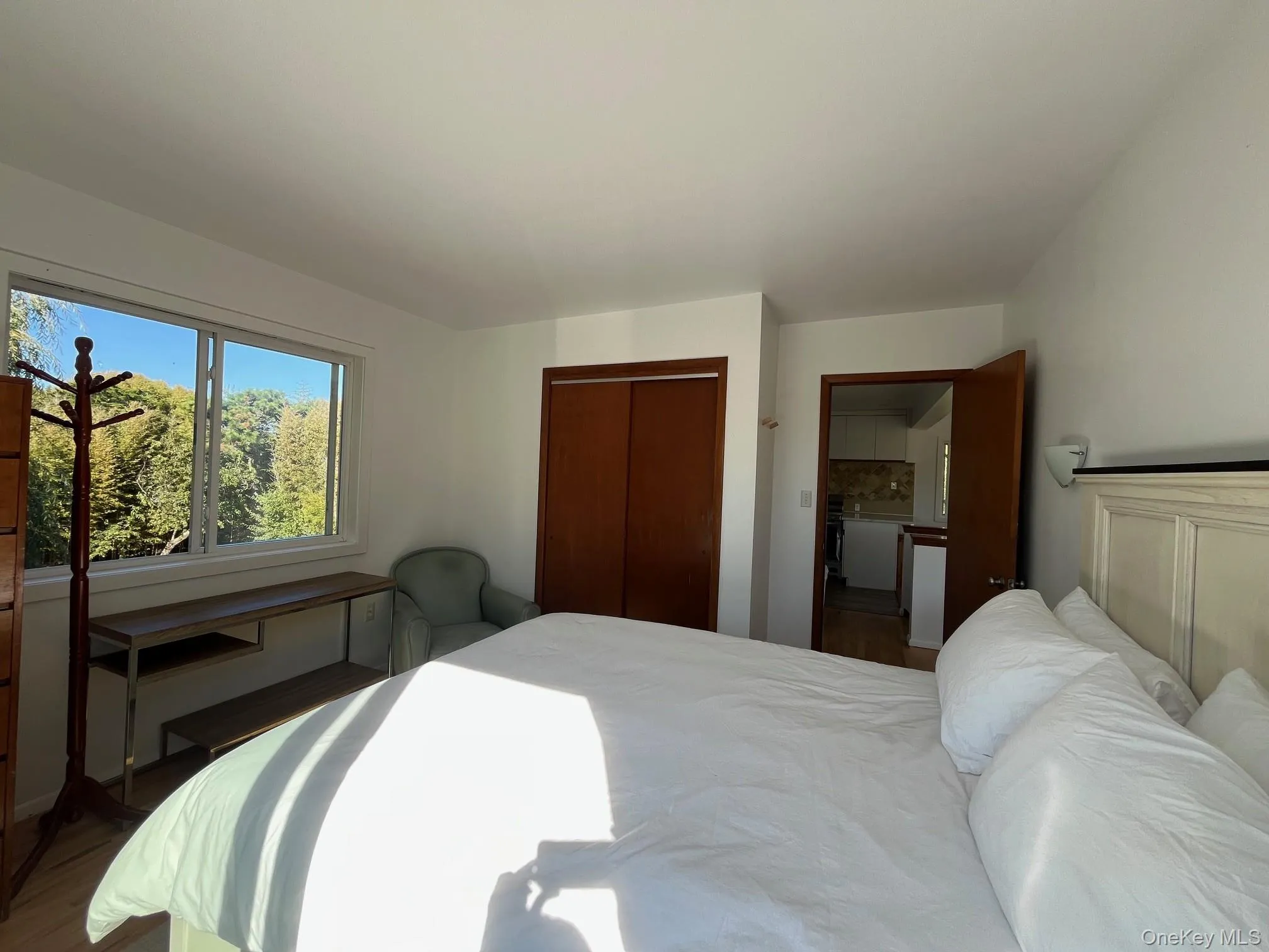 Bedroom featuring a closet and wood finished floors Bedroom featuring a closet and wood finished floors