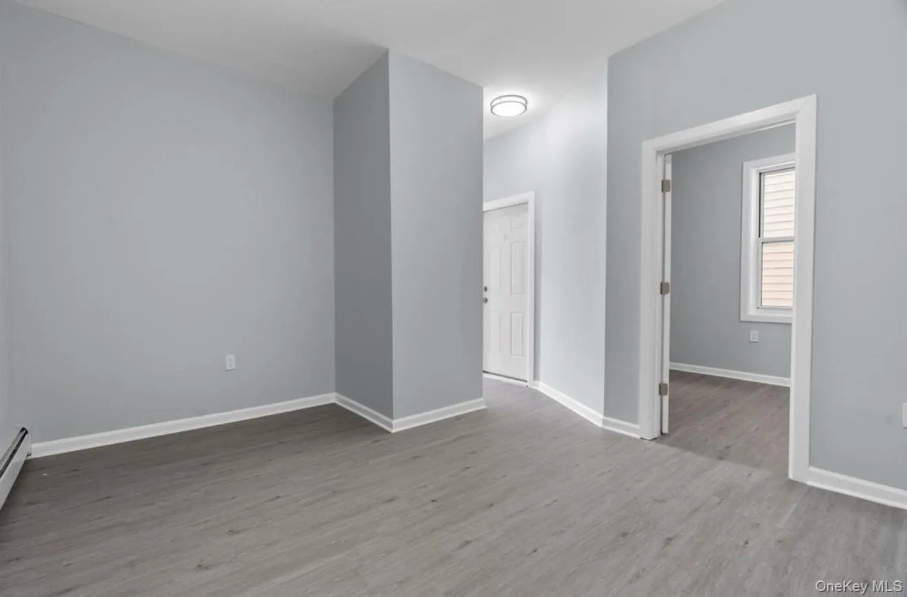 Spare room featuring light wood finished floors and baseboards Spare room featuring light wood finished floors and baseboards