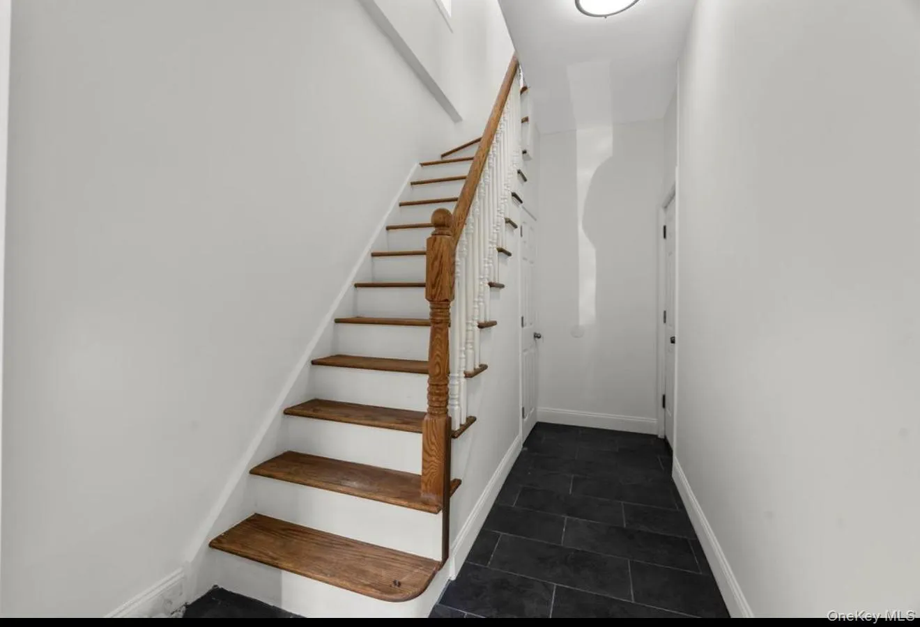 Stairs with baseboards and tile patterned floors Stairs with baseboards and tile patterned floors