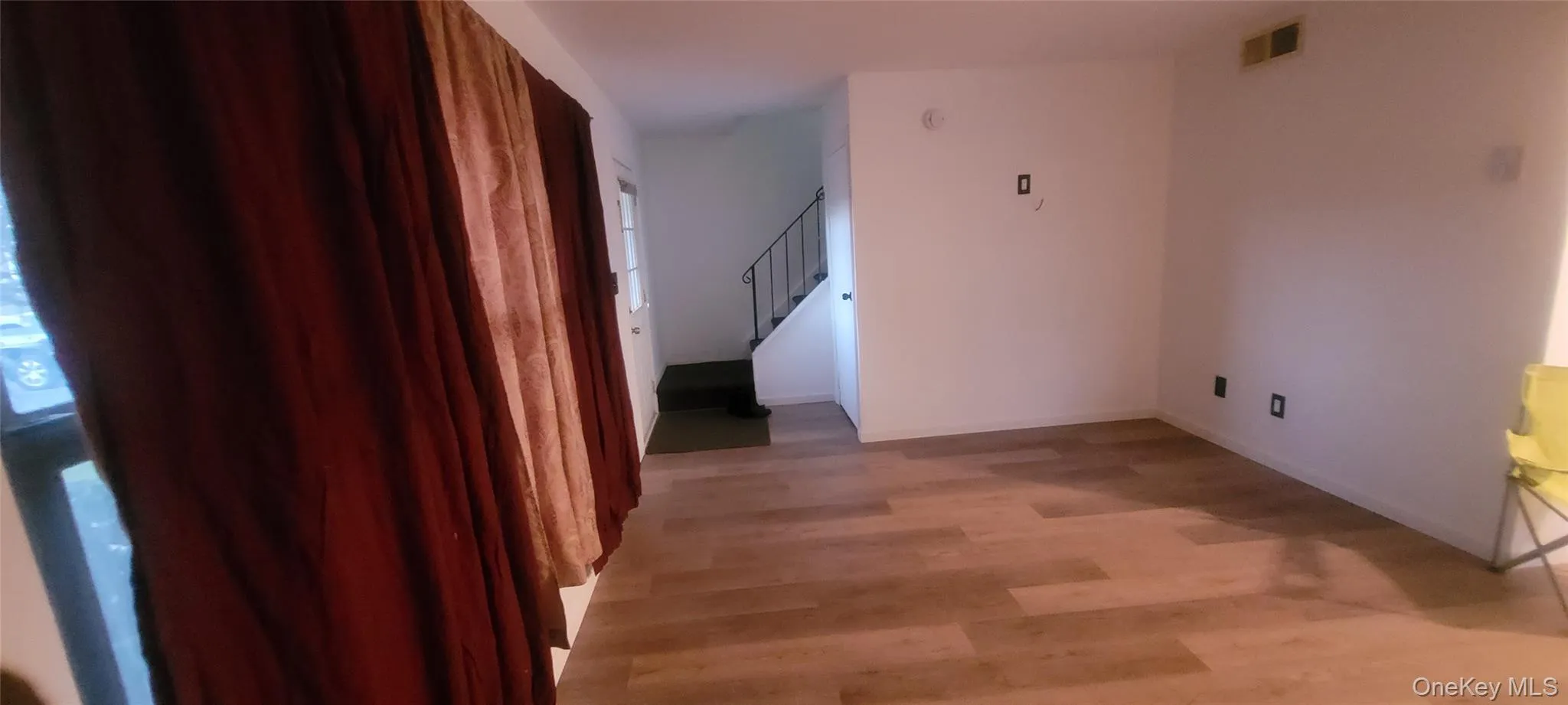 Corridor featuring light wood-style floors and stairs Corridor featuring light wood-style floors and stairs