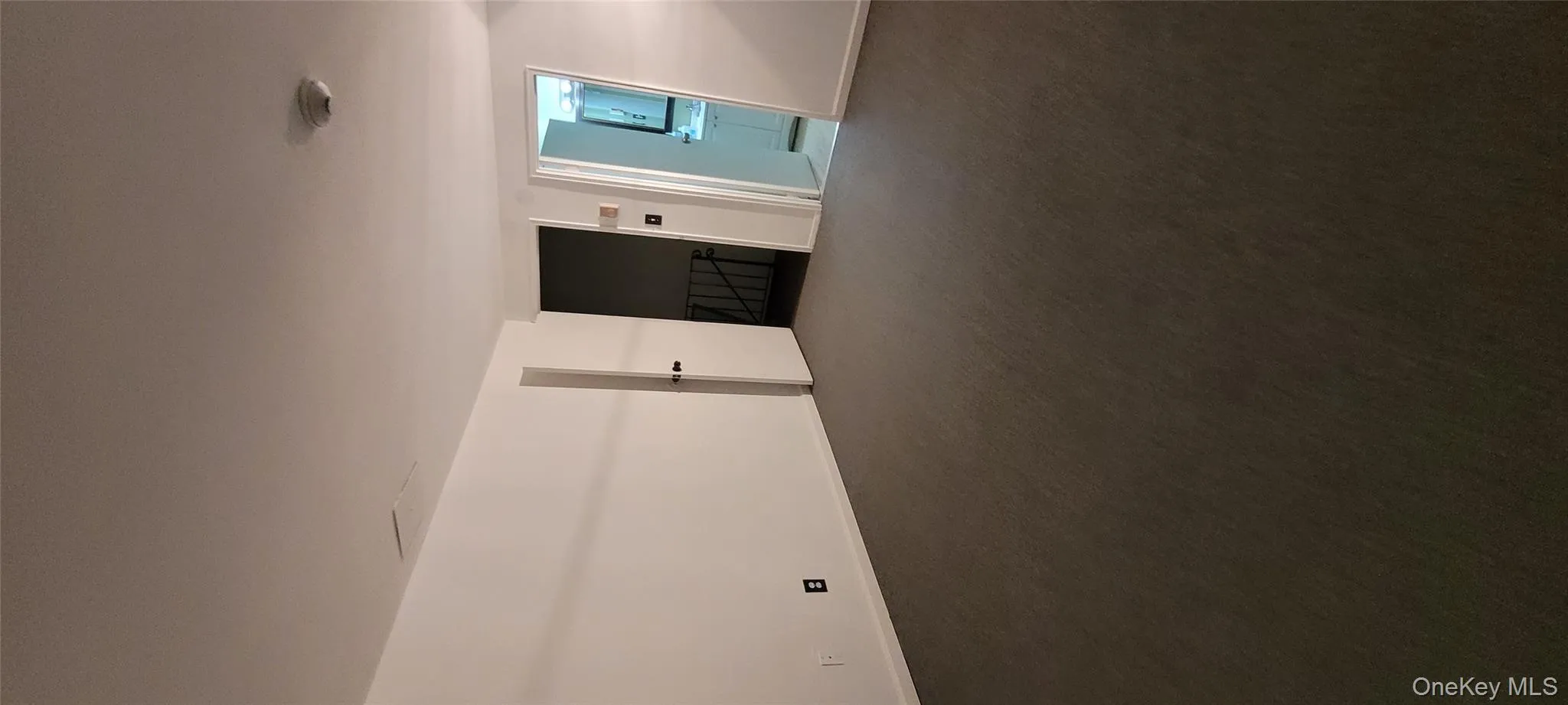 Empty room with dark colored carpet and baseboards Empty room with dark colored carpet and baseboards