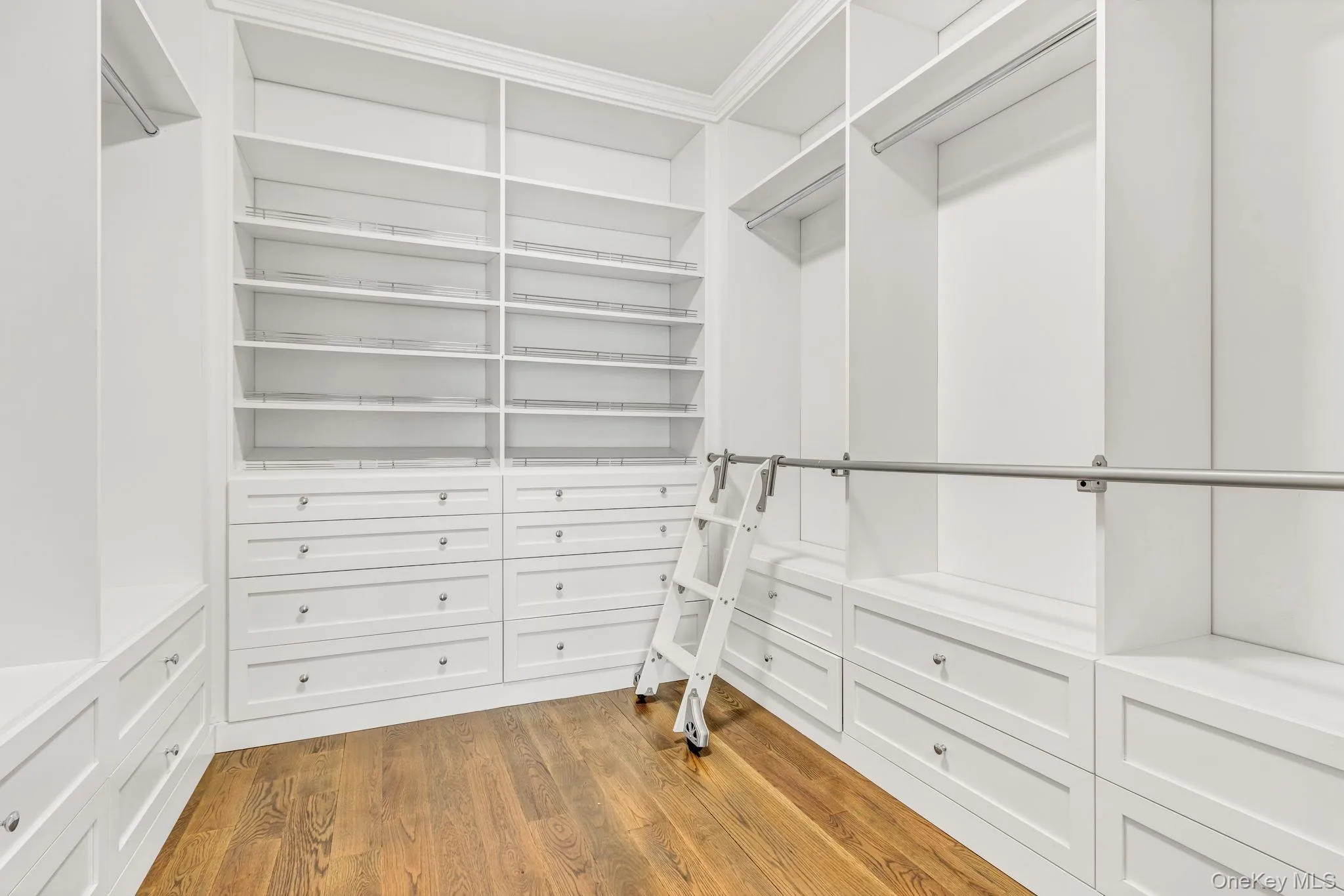 Walk in closet featuring light wood-type flooring Walk in closet featuring light wood-type flooring
