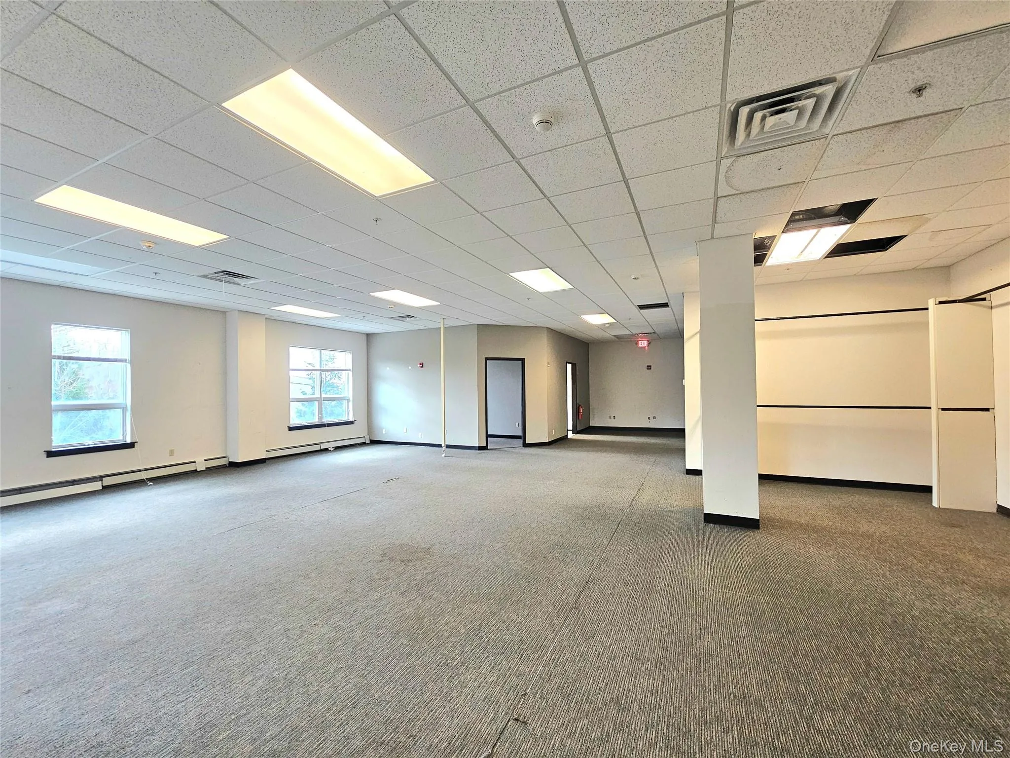 Unfurnished room featuring a paneled ceiling and carpet Unfurnished room featuring a paneled ceiling and carpet